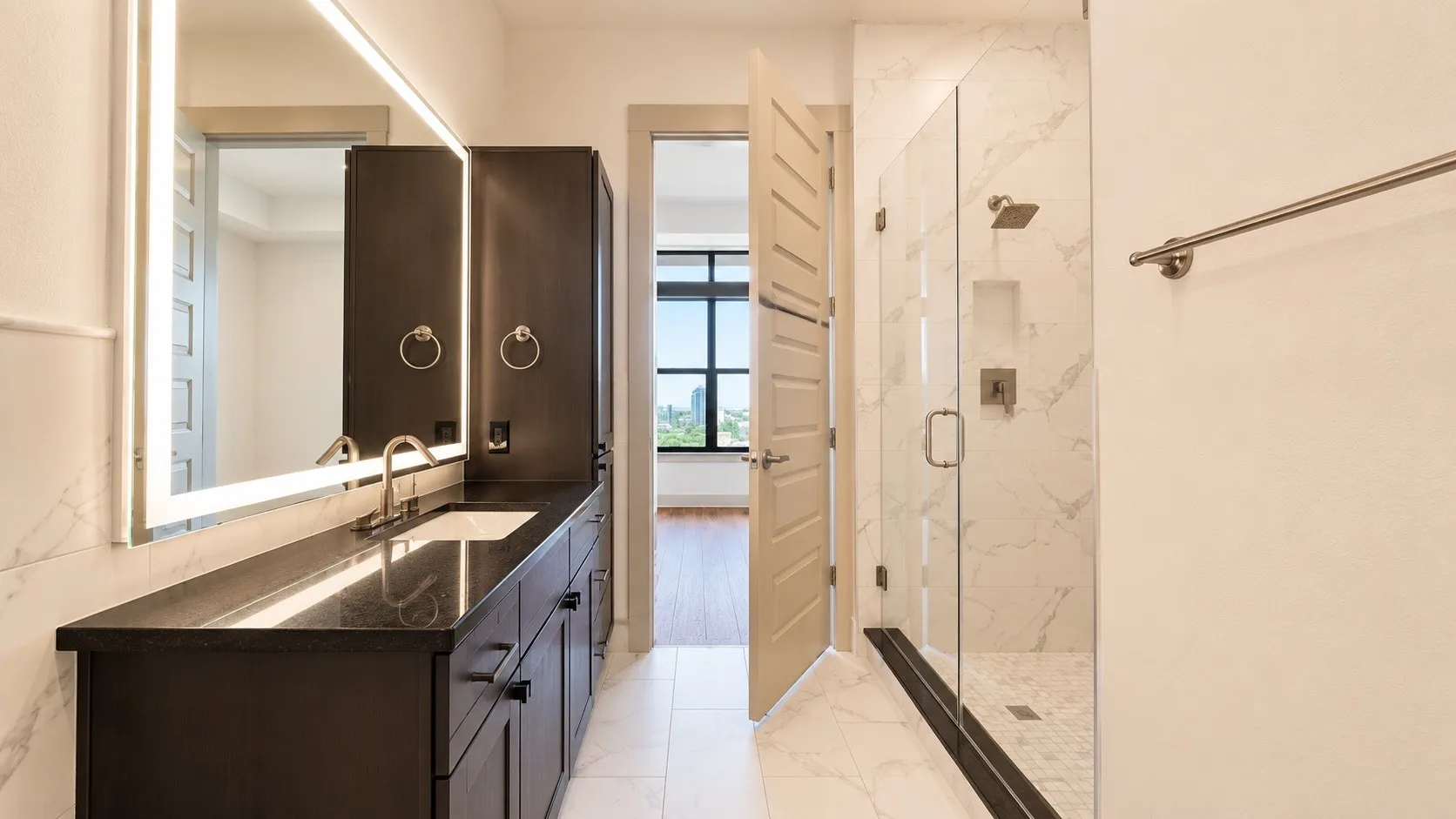 Bathroom featuring a spacious walk-in shower with a glass enclosure, rainfall showerhead, and a built-in niche