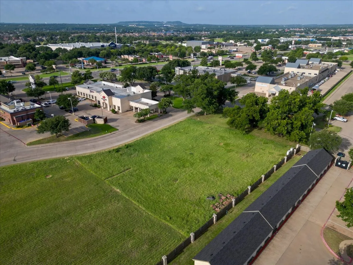 Expansive green lot with established perimeter fencing