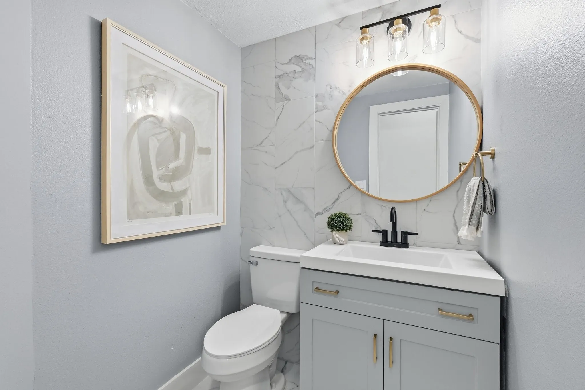 210 Canyon Oaks, Argyle, TX 76226 - Half Bath - Modern half bathroom featuring a single vanity with a white integrated sink, matte black faucet, and light gray cabinetry