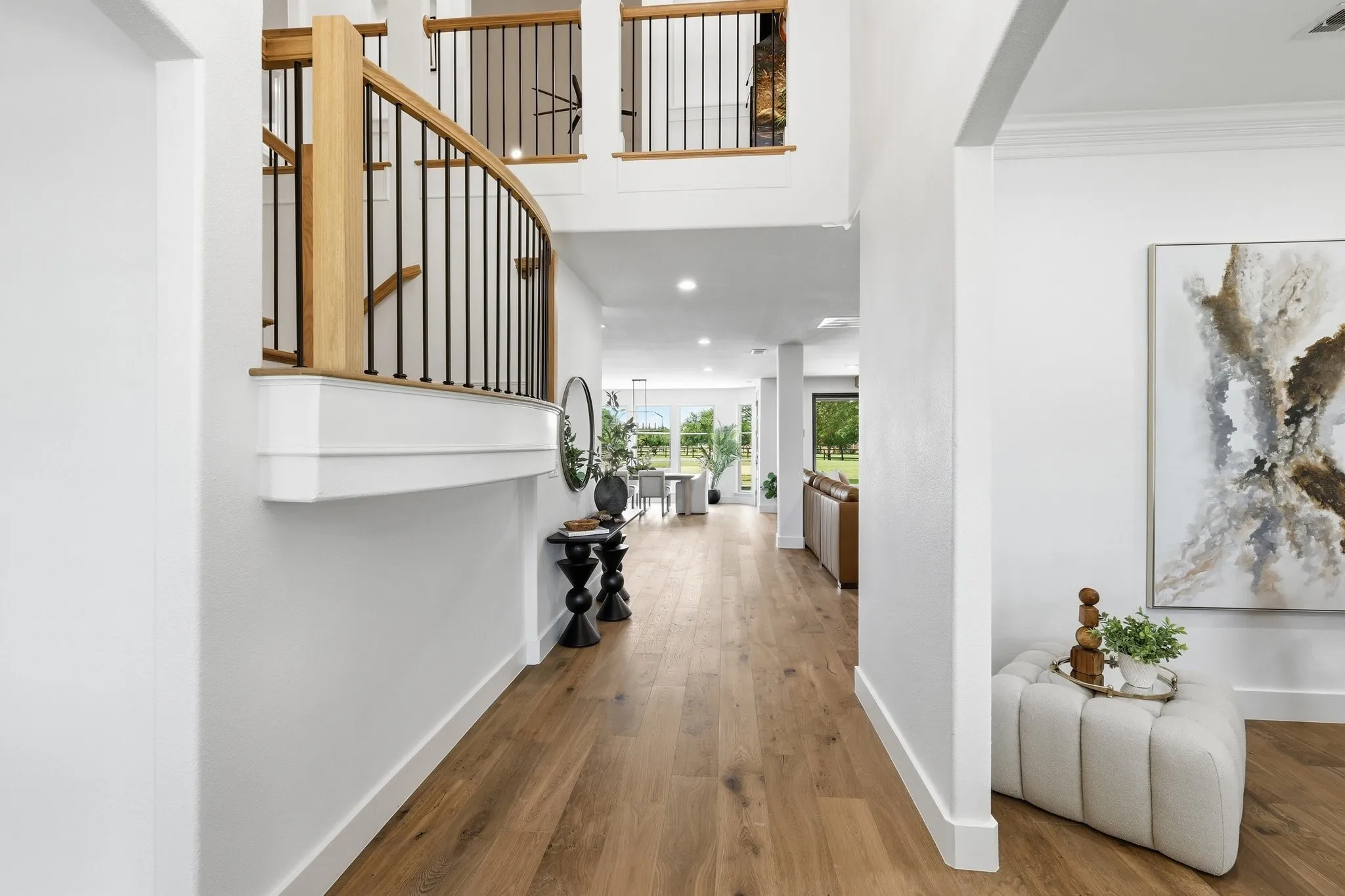210 Canyon Oaks, Argyle, TX 76226 - Entrance Two-story foyer featuring a curved staircase with natural wood handrails and black metal balusters