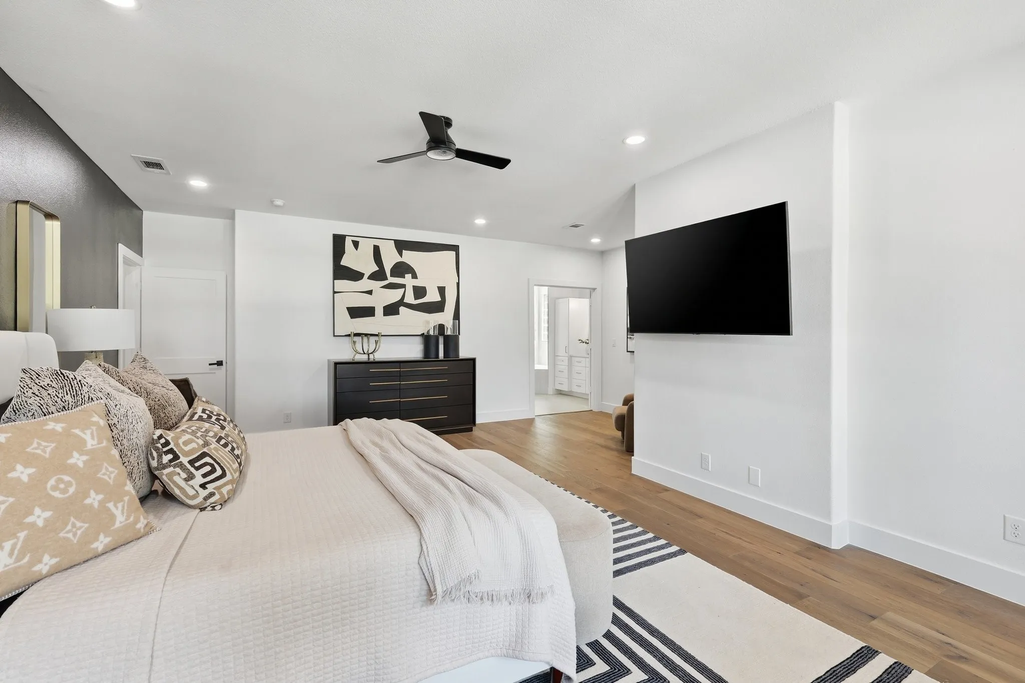 210 Canyon Oaks, Argyle, TX 76226 - Primary Bedroom - Spacious primary bedroom featuring wood-finish flooring, recessed lighting, and a contemporary ceiling fan