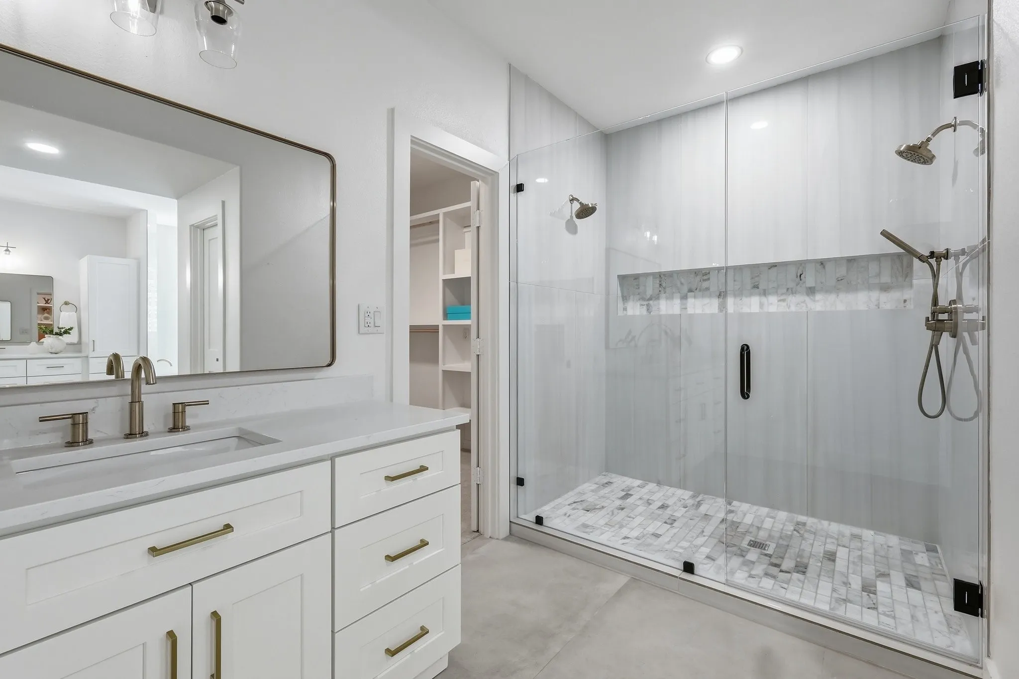 210 Canyon Oaks, Argyle, TX 76226 - Primary Bathroom - White vanity with brushed brass hardware, undermount sink, and a framed rectangular mirror