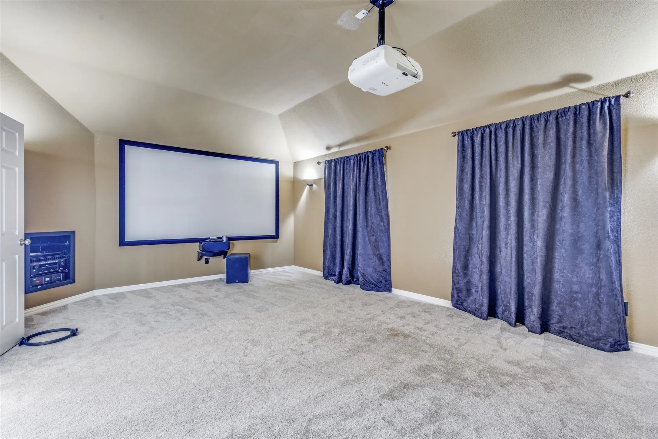 Unfurnished flex room with ceiling fan, light carpet, and tray ceiling, offering endless possibilities as a bedroom, home office, fitness room, nursery, craft room, media room, or extra living space in this traditional McKinney TX home that delivers both functionality and location in Collin County.