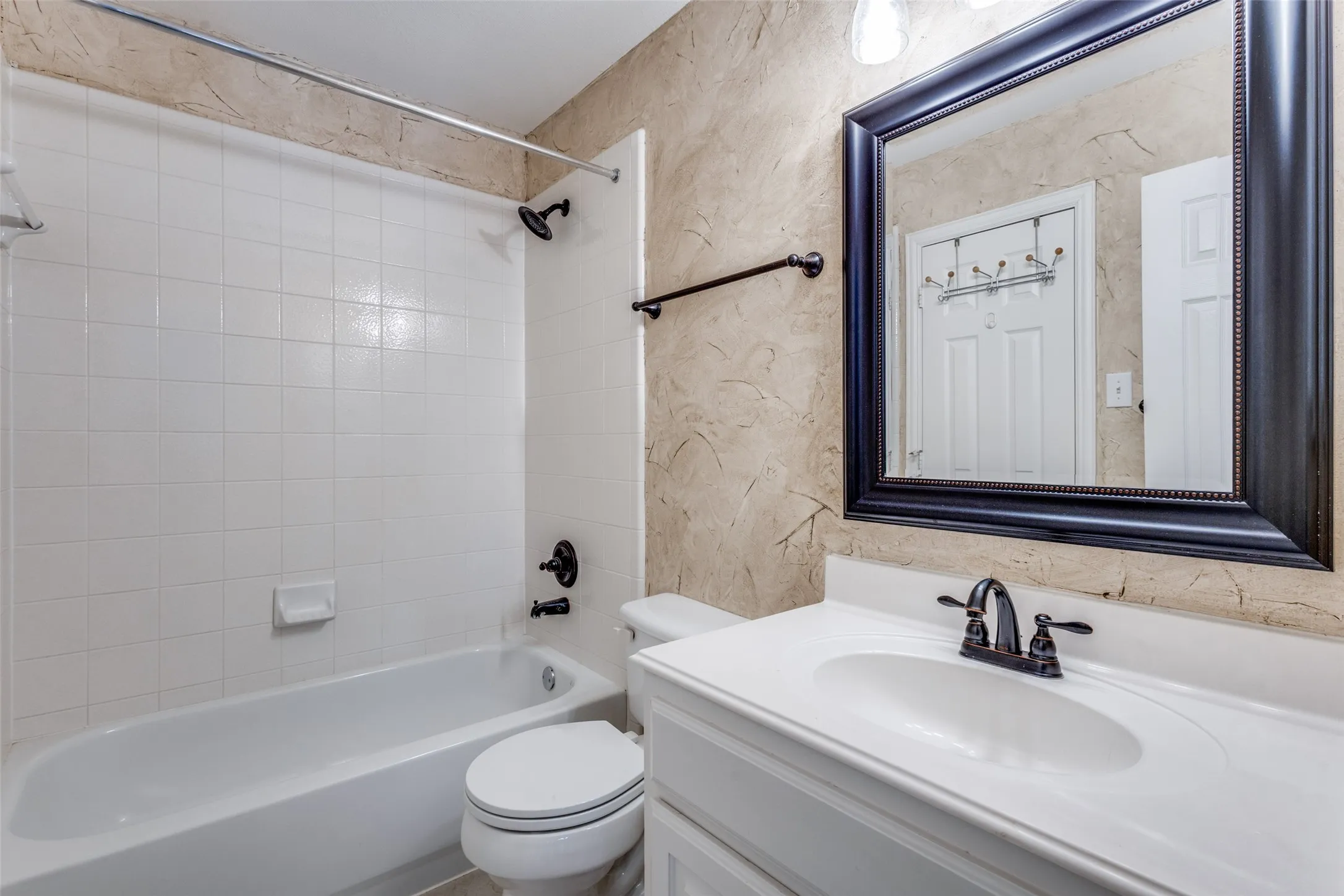 Full bathroom with vanity and shower-tub combination, offering a practical and efficient shared bath space that supports everyday living in this spacious McKinney Texas property, appealing to buyers searching for a well-designed home in McKinney ISD, Collin County, and the Virginia Woods subdivision.