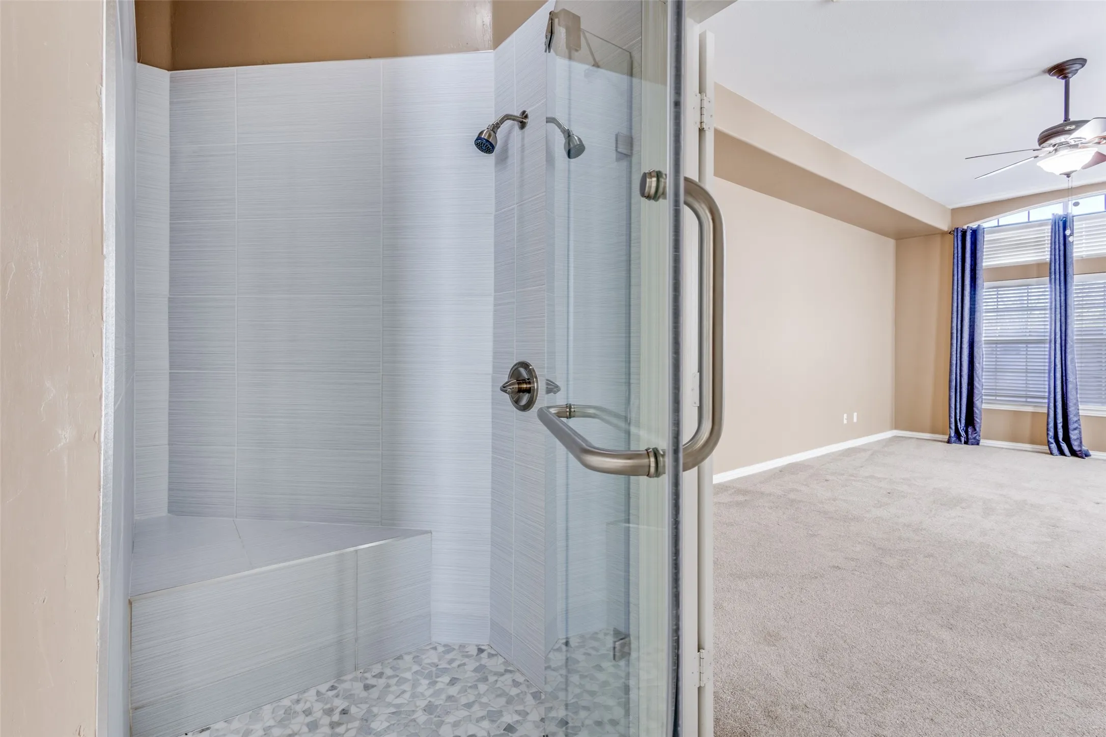 Full bathroom with stall shower, light carpet, and ceiling fan, offering a convenient secondary bath configuration that supports comfortable everyday living for families searching for a spacious McKinney Texas home in Virginia Woods with multiple bedrooms and flexible upstairs spaces.