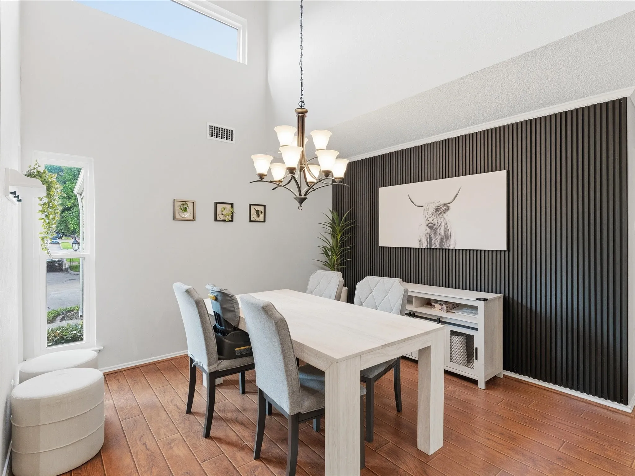 Dining space featuring a vaulted ceiling and a high transom window