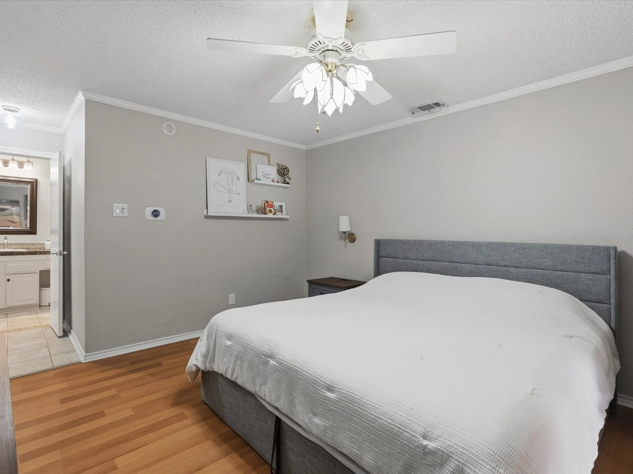 Wood-finish flooring throughout, complemented by a ceiling fan with light fixture