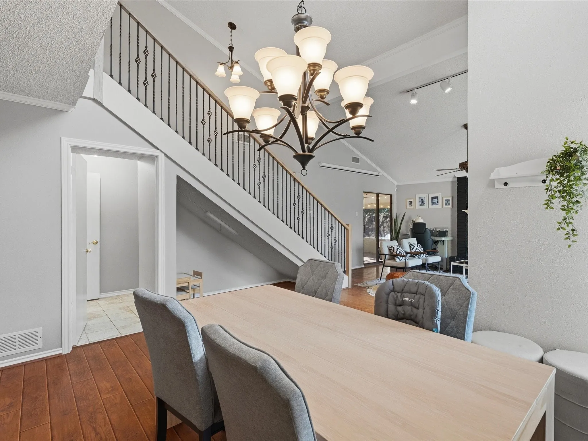 Dining area with a multi-light chandelier and wood-finish flooring