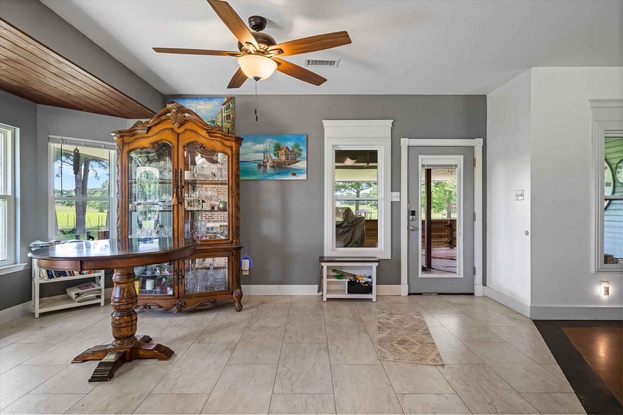Where kitchen, dining and living room meet the back door that leads out to the covered and enclosed back patio