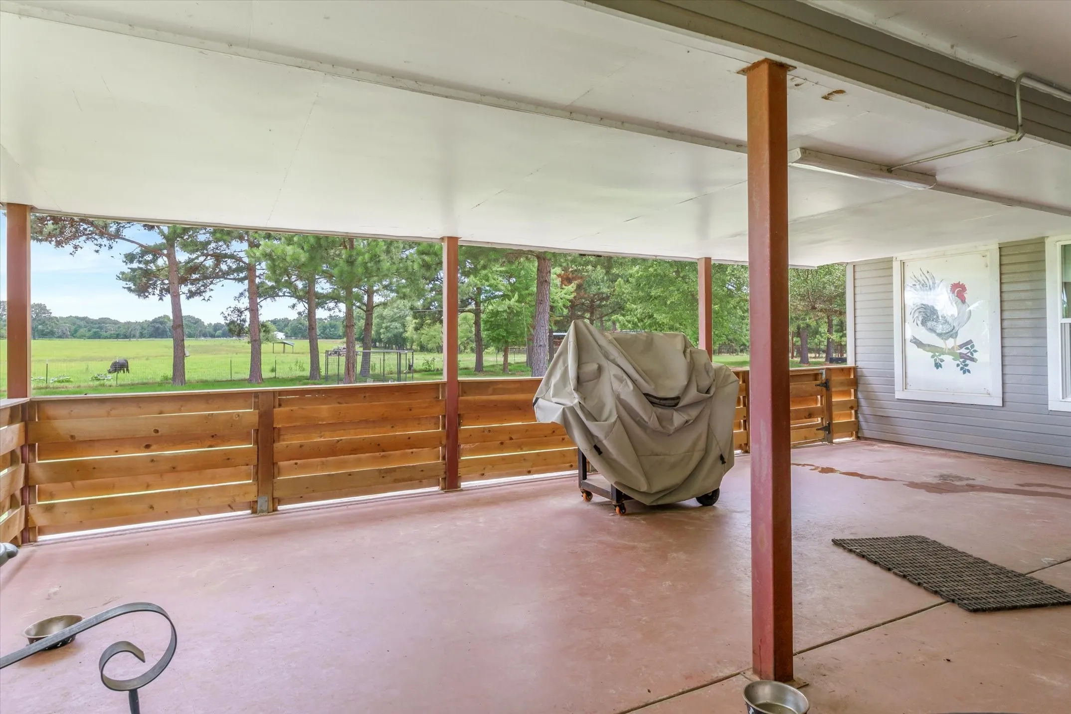 Covered and enclosed patio has all the great pasture views