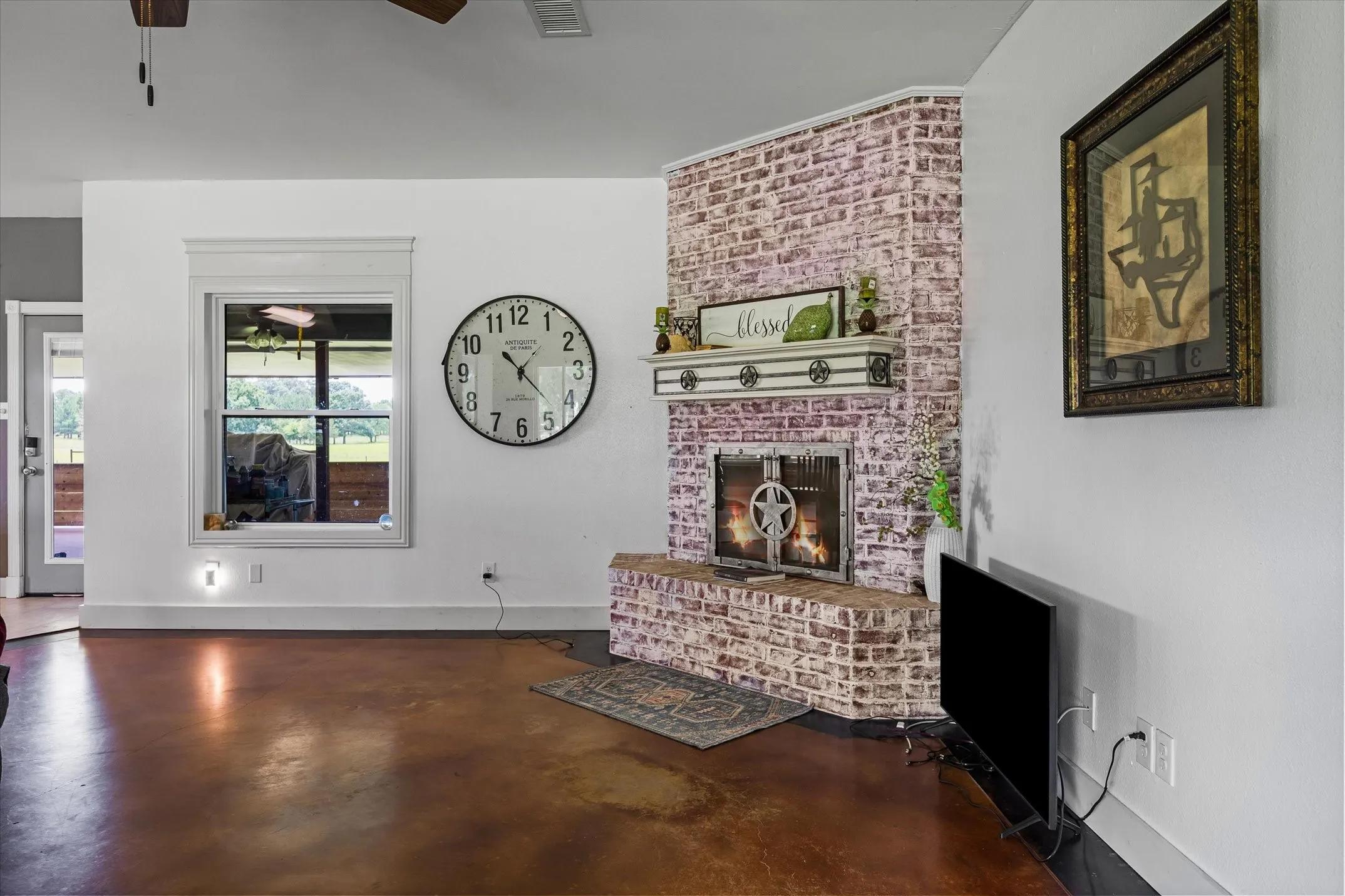 Great living room space just off the kitchen and dining with stained concrete floors