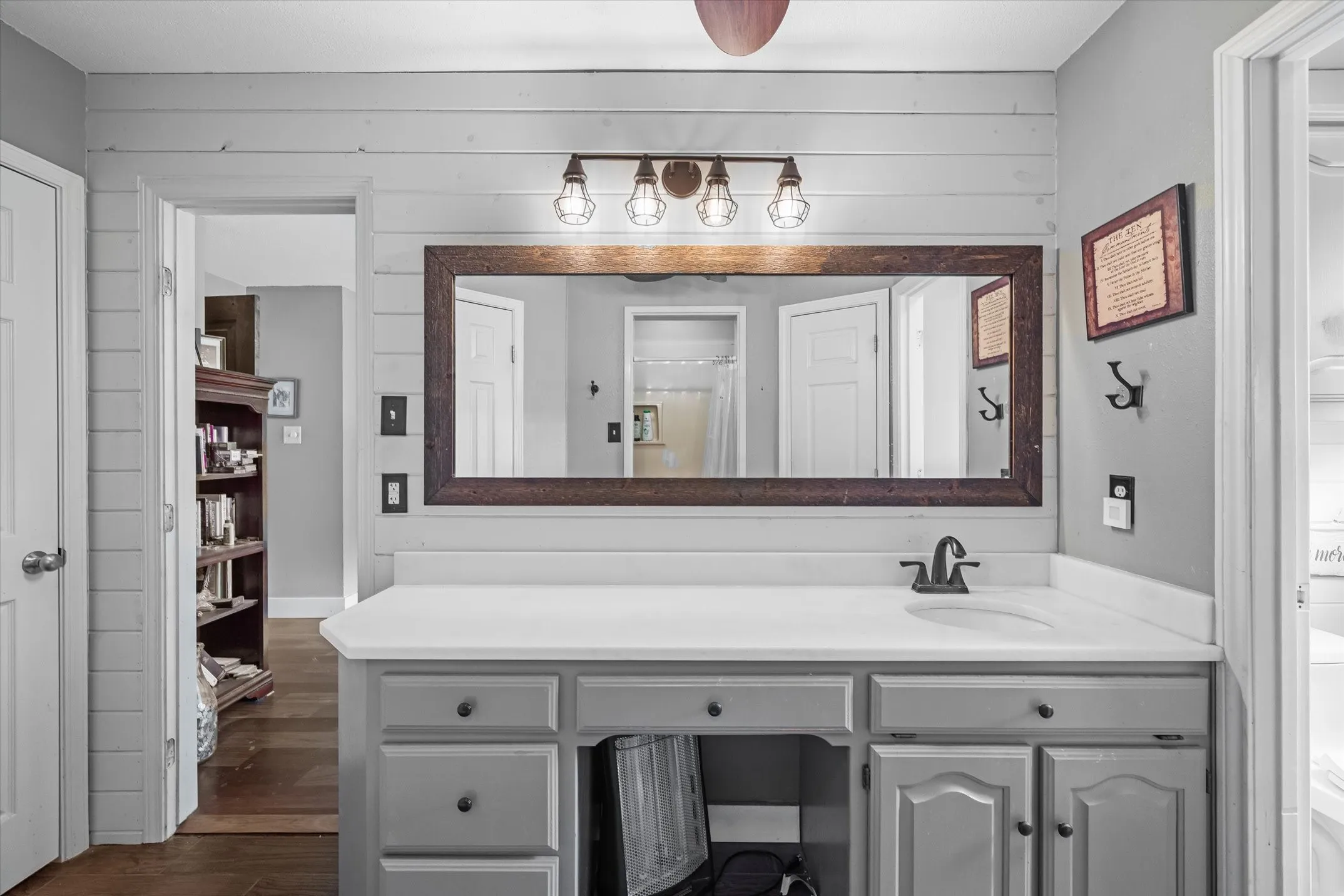 Shiplap walls and rustic mirror and decorative lights