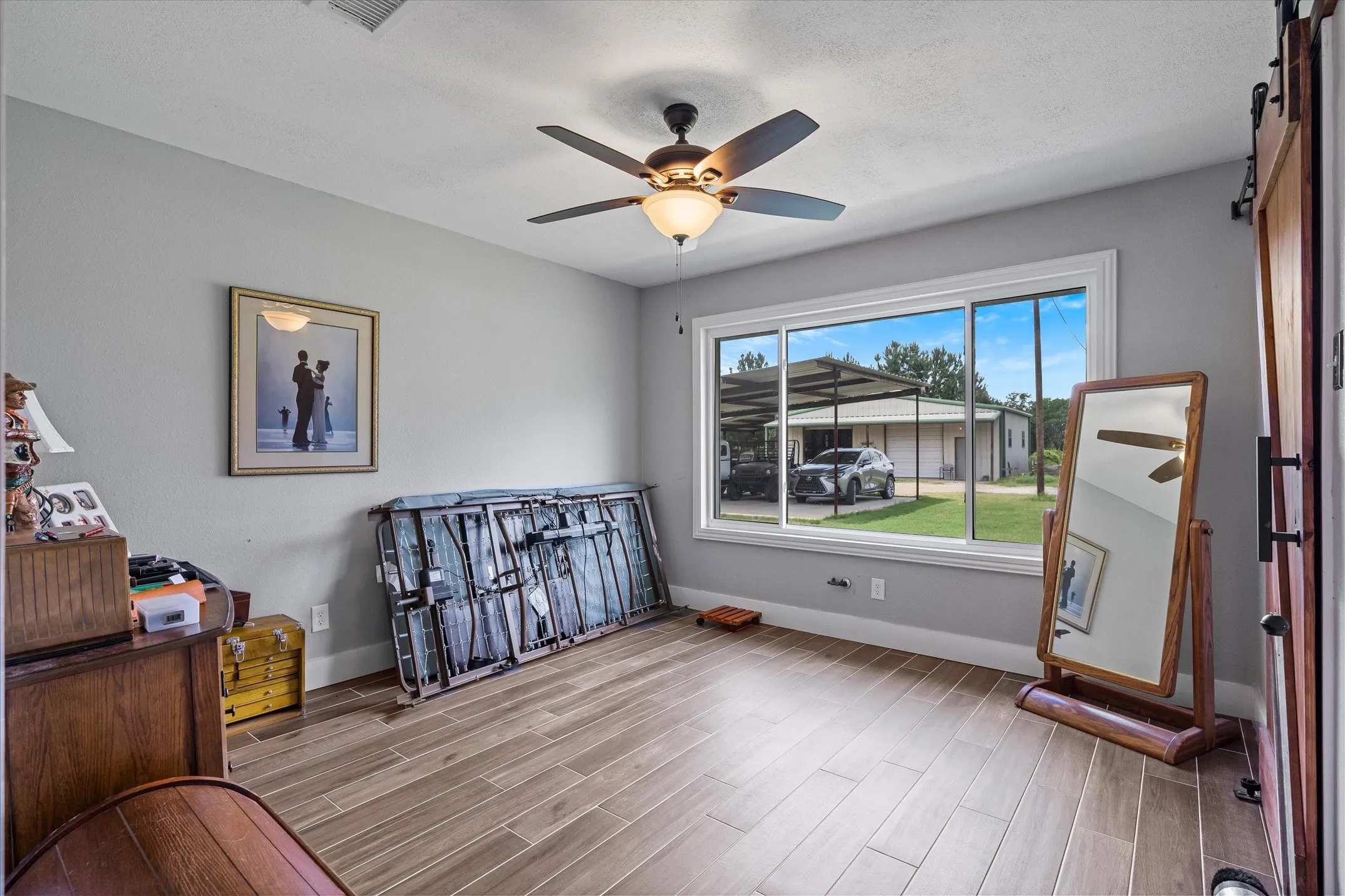 Bedroom 2 with a large picture window and wood ceramic tile flooring