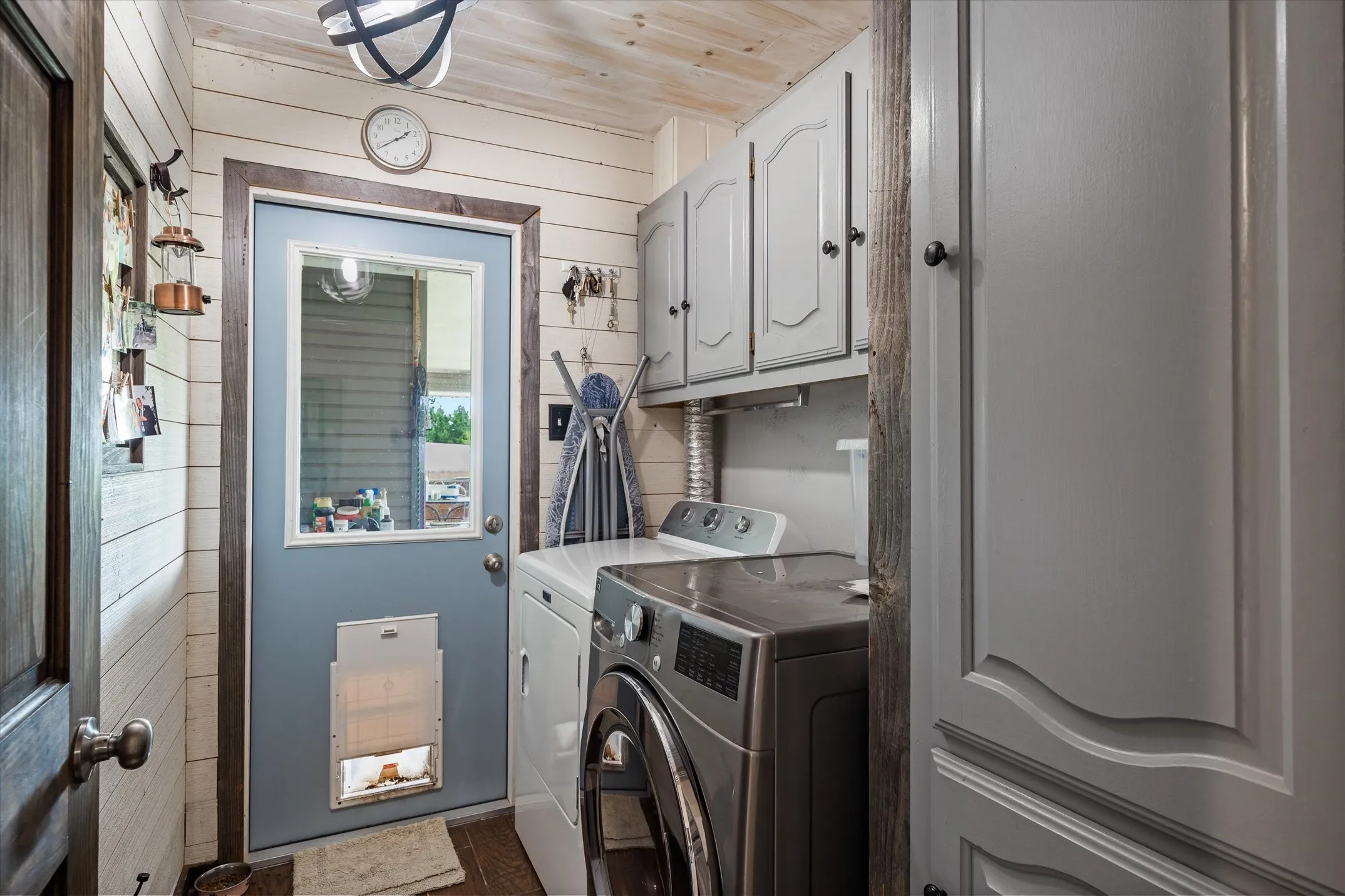 Super sweet laundry room with shiplap walls and ceiling