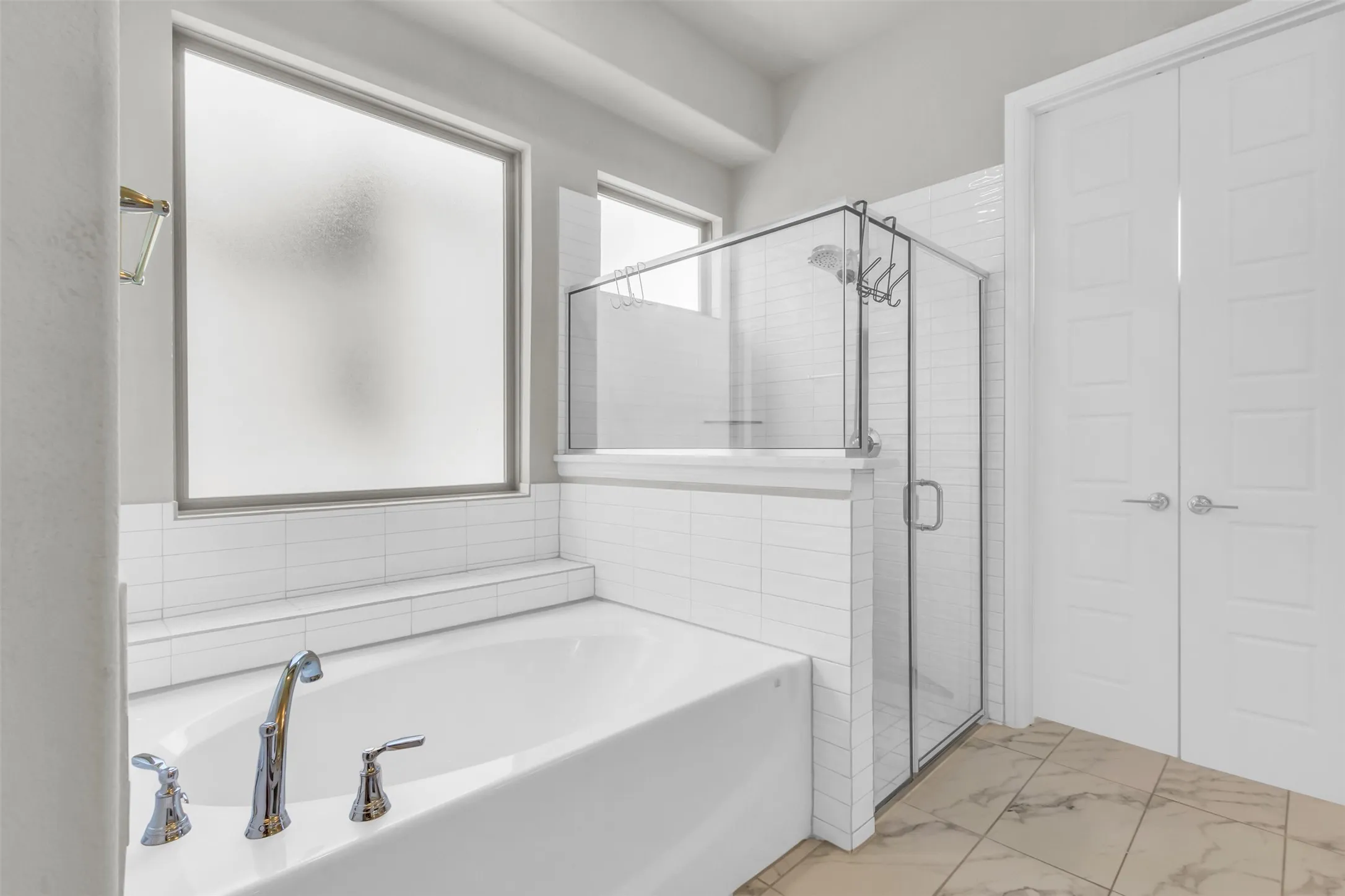 Bathroom featuring tile patterned flooring and plus walk in shower