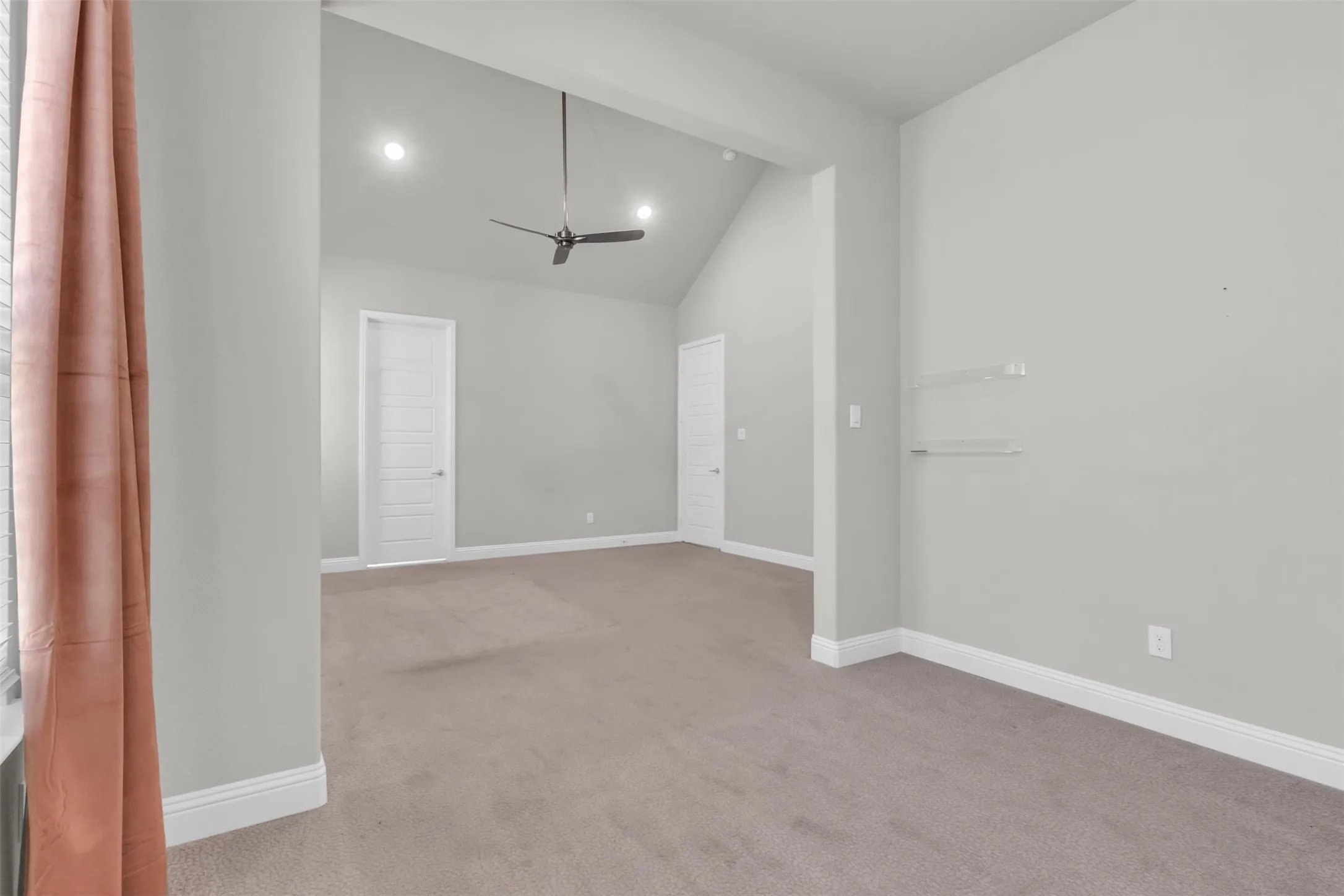 Unfurnished room with lofted ceiling, carpet, and ceiling fan