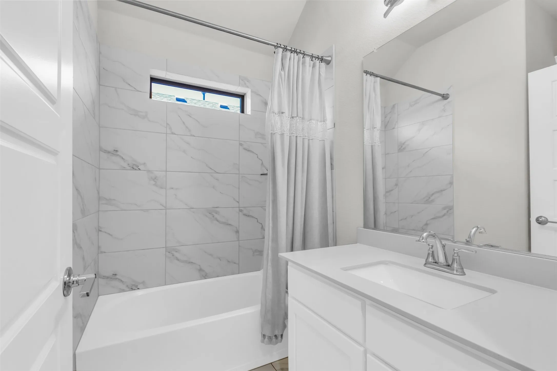 Bathroom with vanity and shower / bath combo with shower curtain