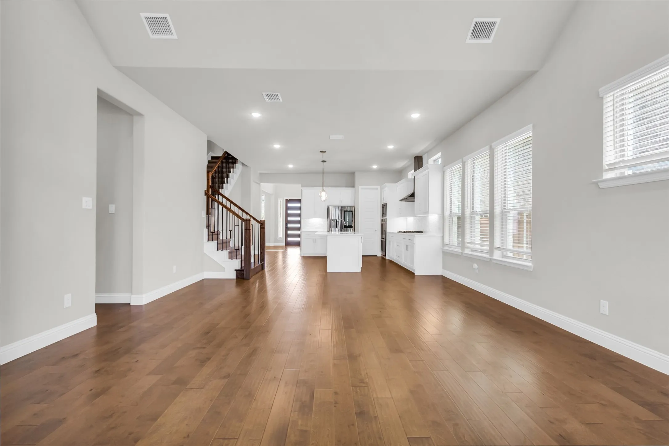 Unfurnished living room featuring dark wood-type flooring