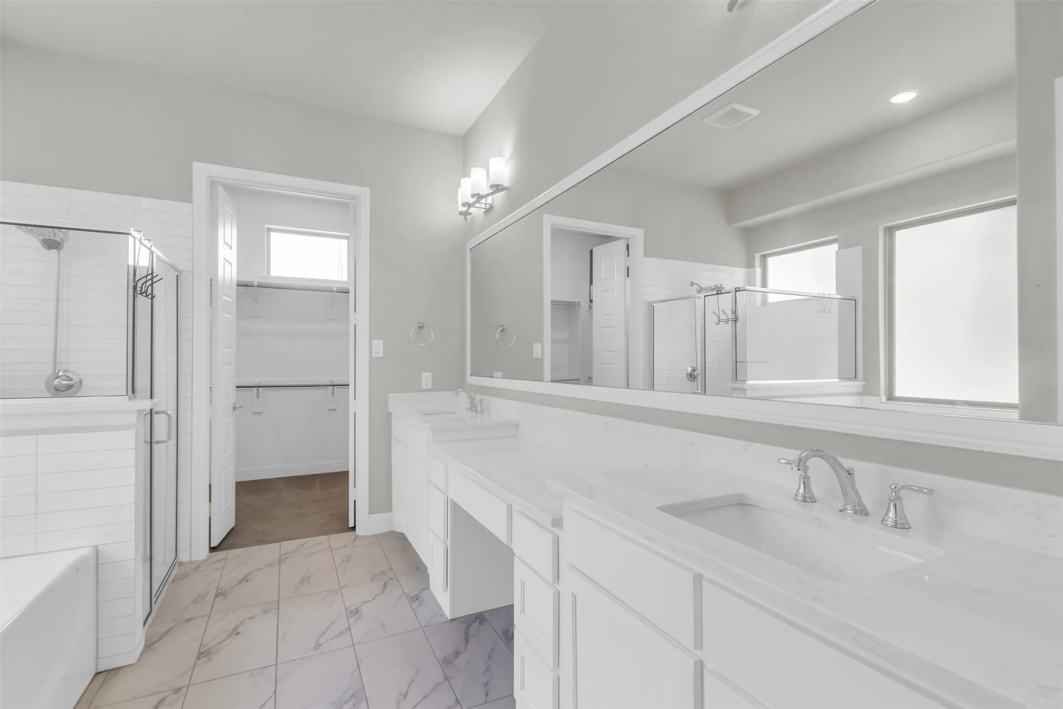 Bathroom with shower with separate bathtub, tile patterned flooring, and dual bowl vanity