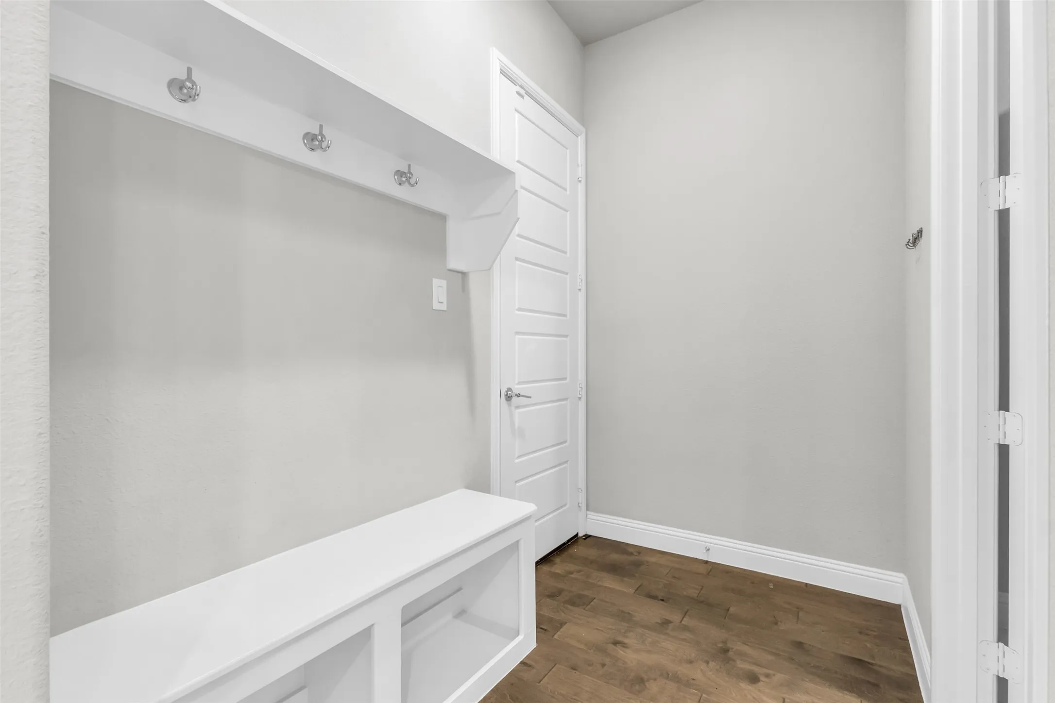 Mudroom with dark hardwood / wood-style flooring