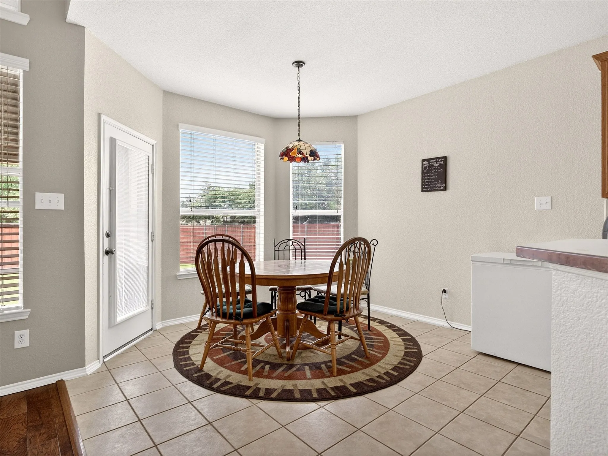 Bay window dining area with ceramic tile flooring
