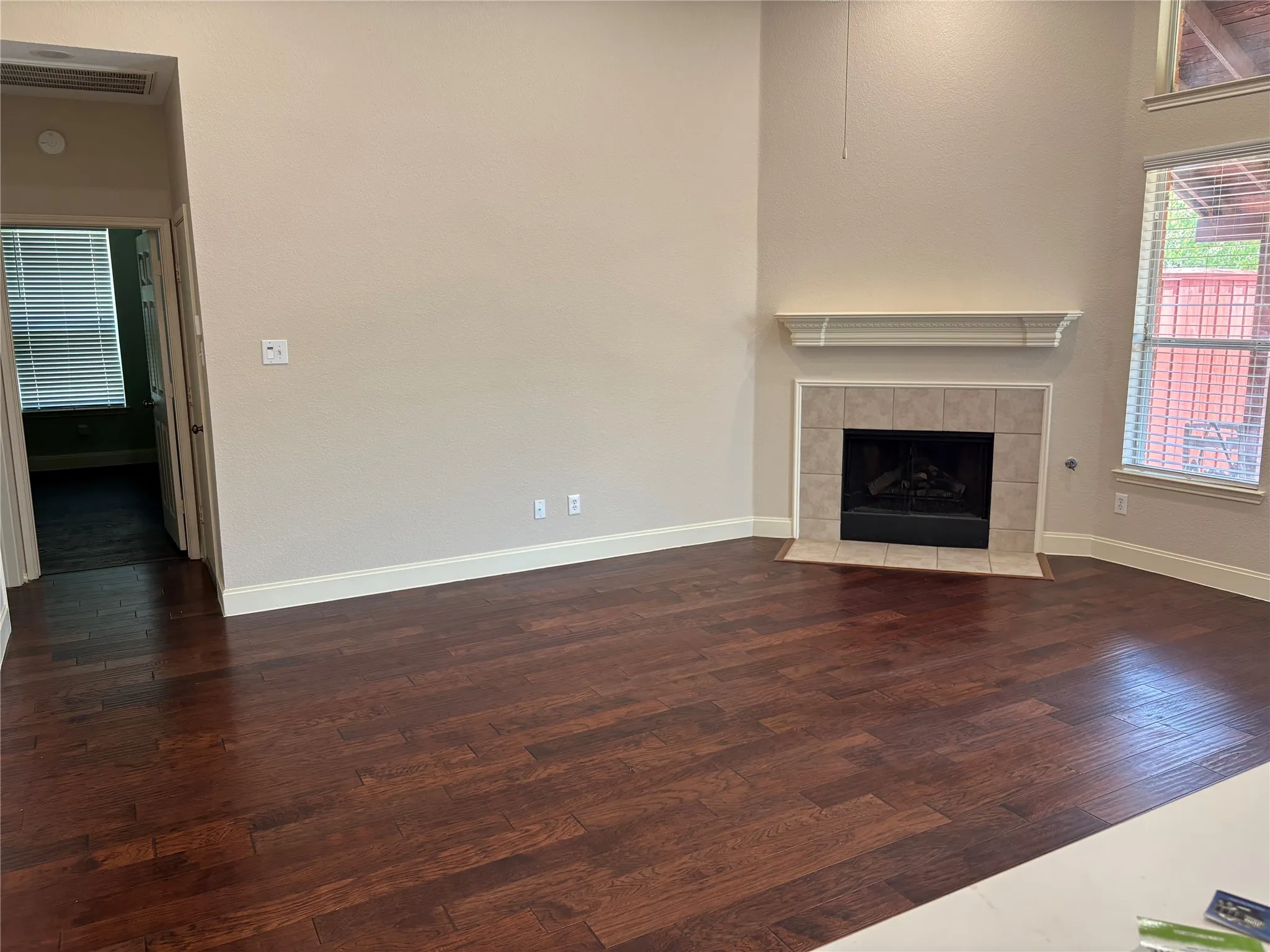 Corner fireplace with tile surround and decorative mantel