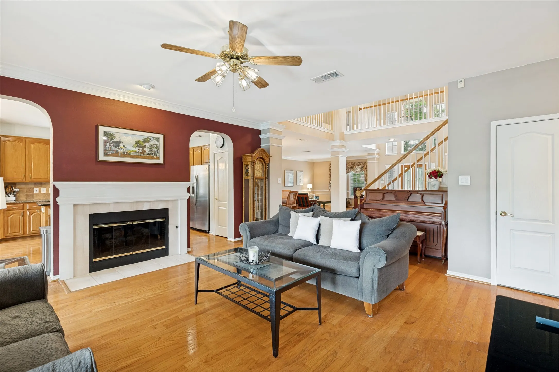Gas fireplace and beautiful archways separate the living room from the large kitchen.