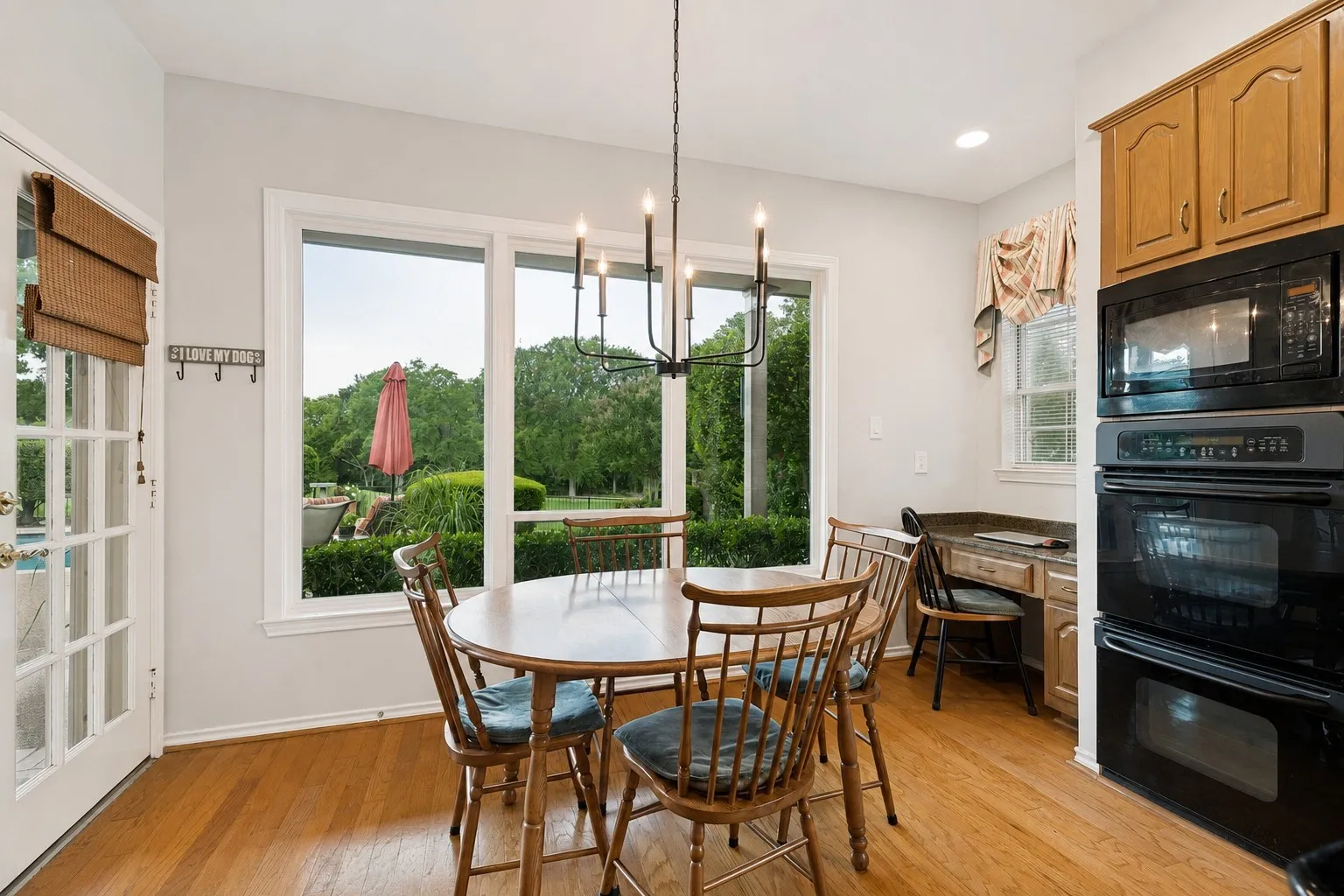 Breakfast area in the kitchen has an amazing view. Notice the double ovens and desk area.