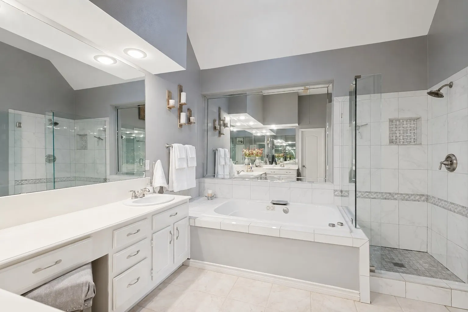 Remodeled primary bathroom has a large shower and separate tub.