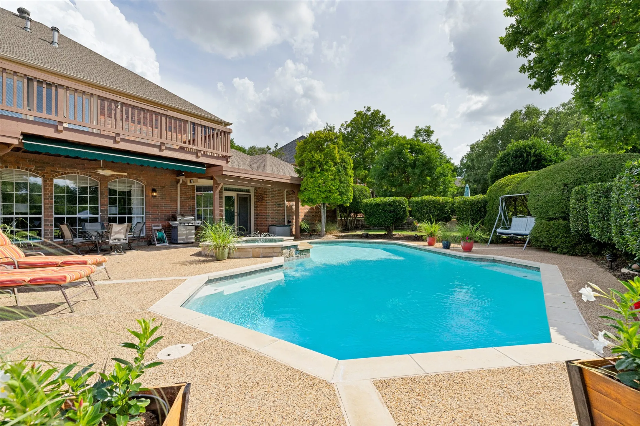 A door from living room takes you out to the covered patio and pool.  The primary suite has a door to the hot tub/spa.