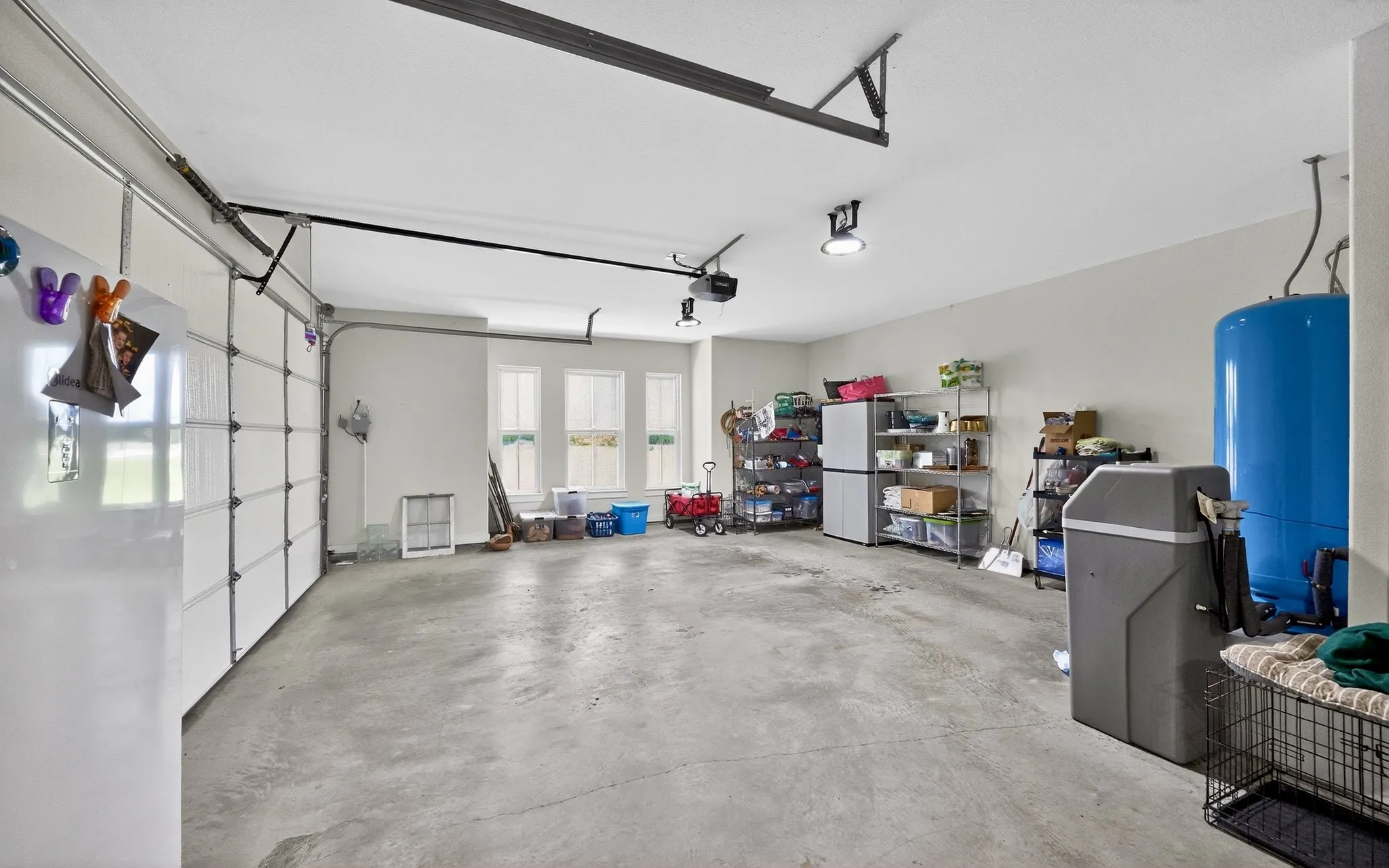 Spacious garage featuring concrete flooring and white walls