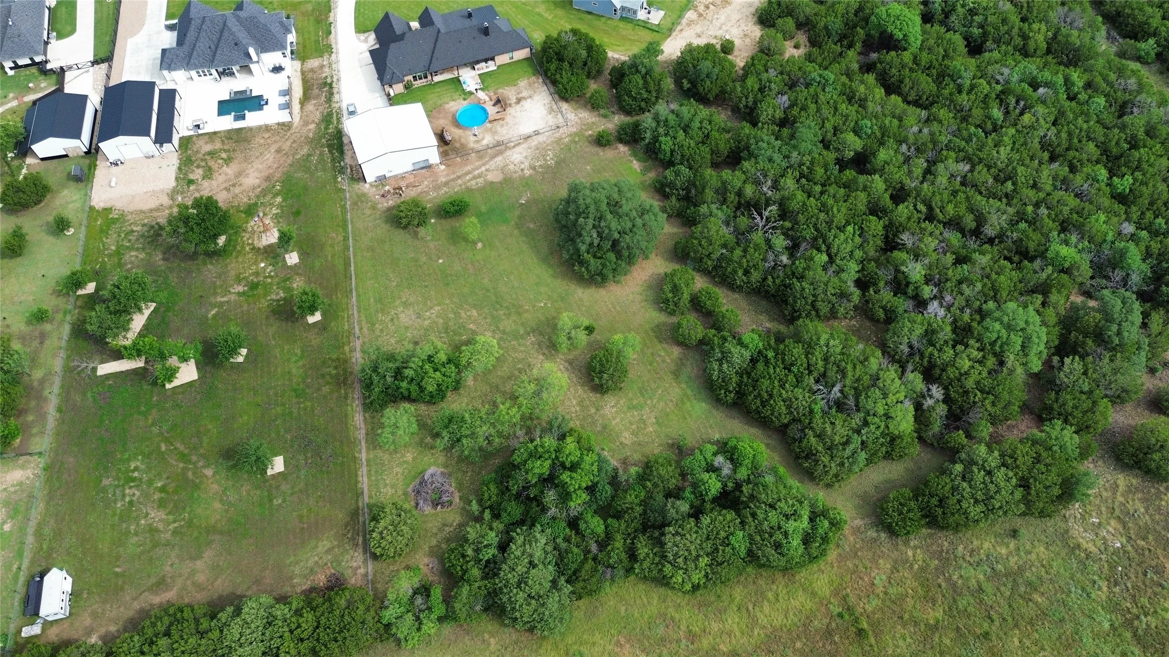 Expansive land parcel featuring a combination of cleared and heavily treed areas
