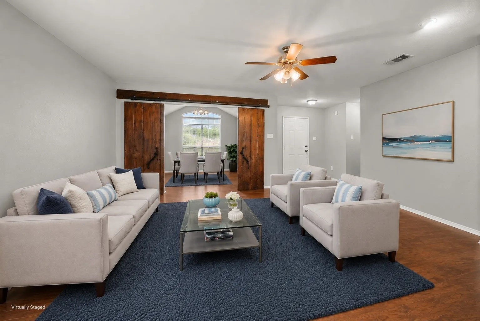 Open-concept living space with wood-finish flooring