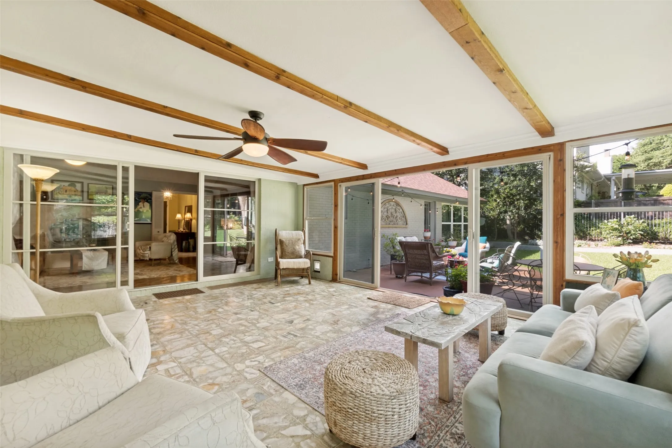The bonus sun room overlooks large lush backyard