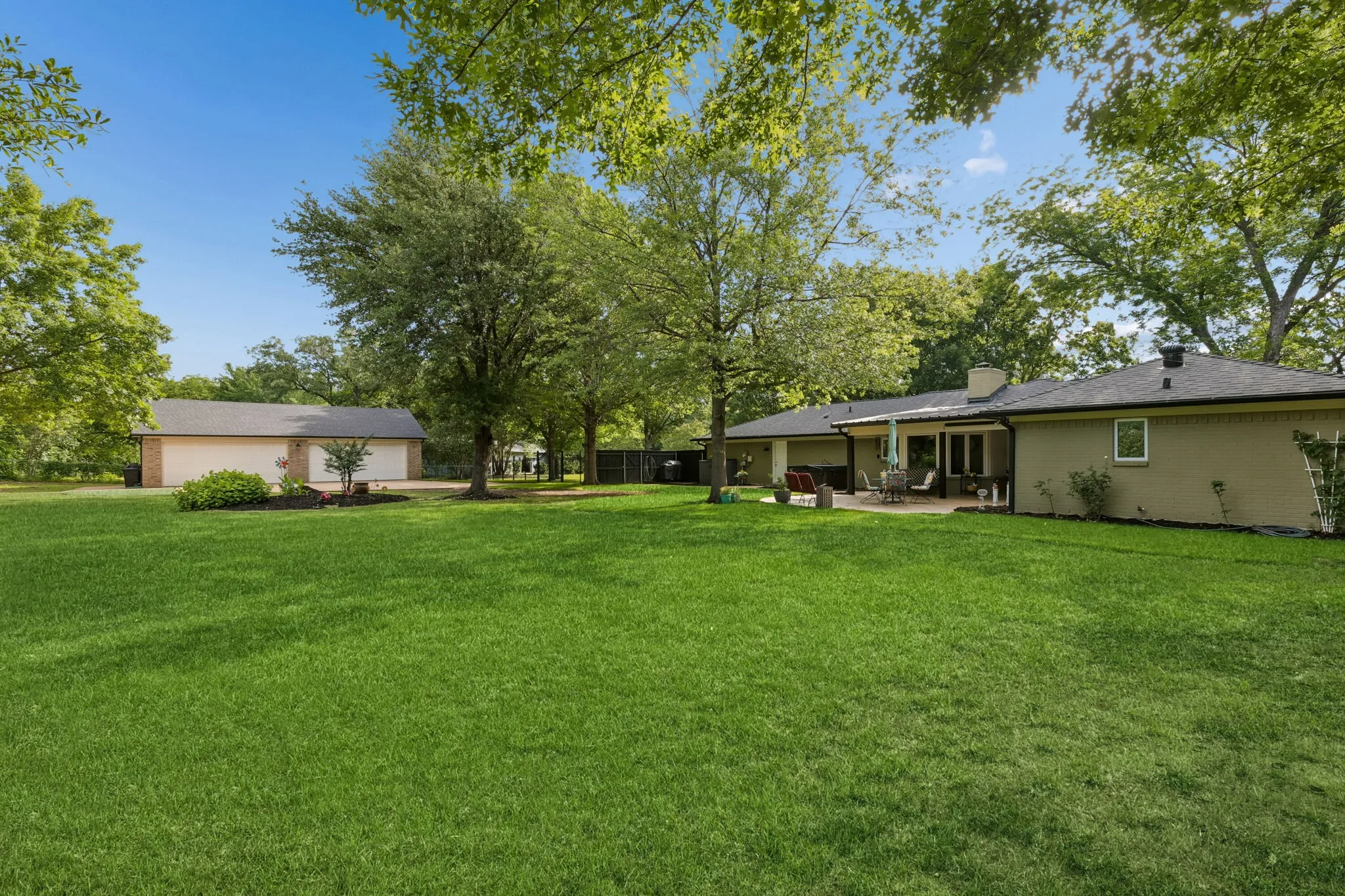another beautiful angle of the huge backyard.  To the left is the separate HUGE 24X40 4 car garage for the car enthusiast.  Also already partially finished out and would make an excellent man cave, gym or the possibilities are endless.