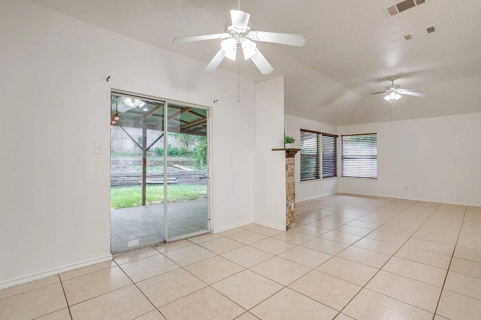 The dining area featuring sliding glass doors leading to the rear exterior of the home.