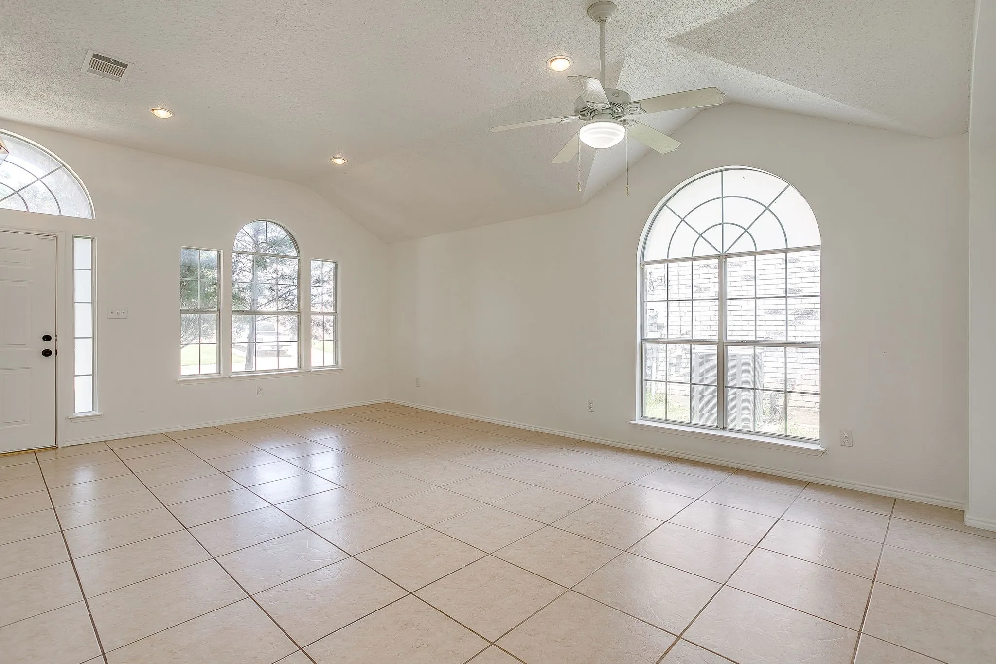The great room featuring a neutral and airy aesthetic.