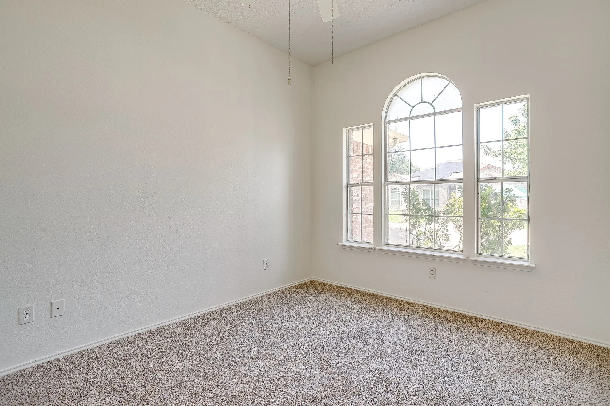Bedroom featuring neutral toned wall color accentuated by ample natural light.