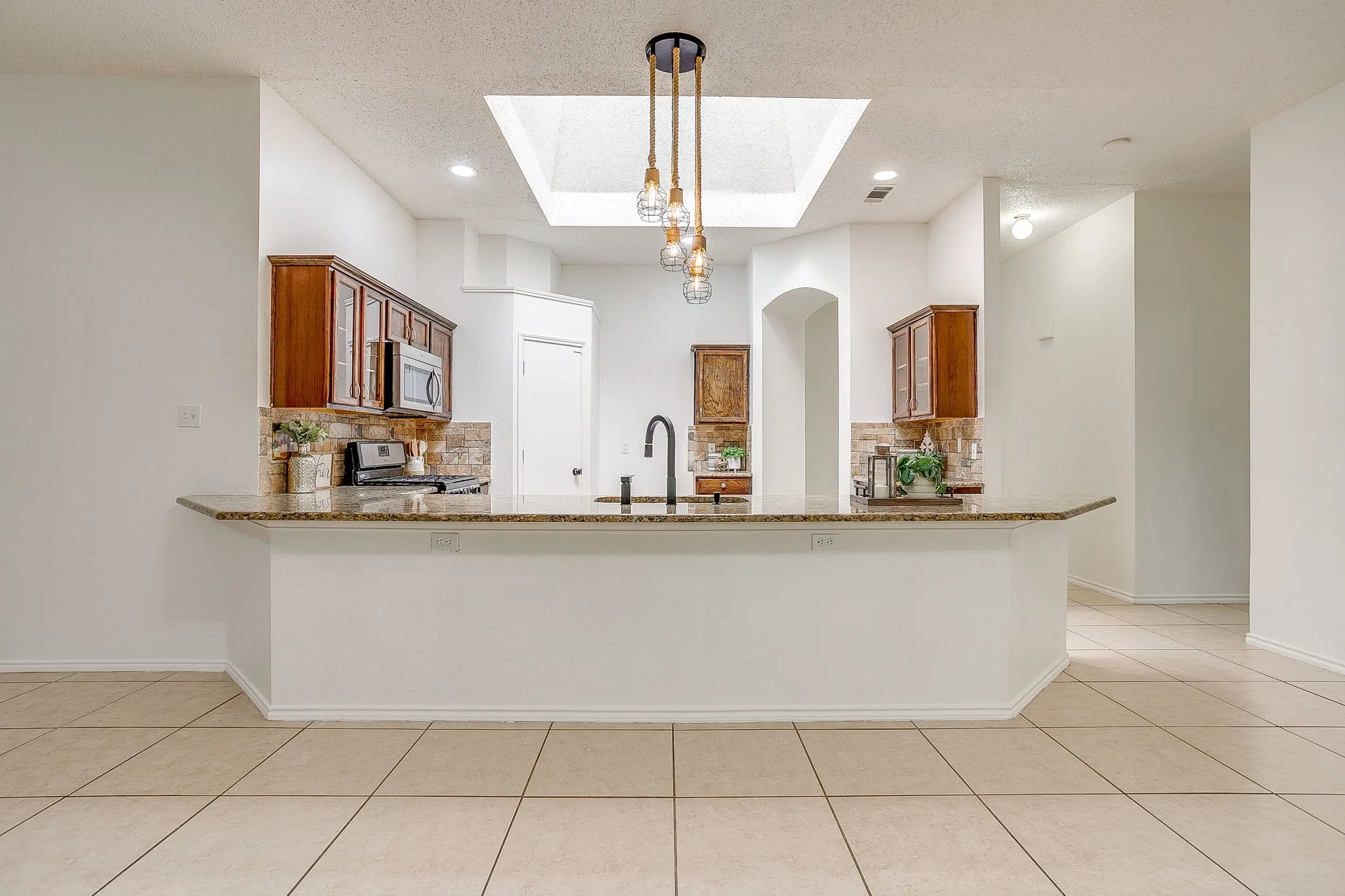 View of kitchen from the dining room featuring a breakfast bar with space for seating.