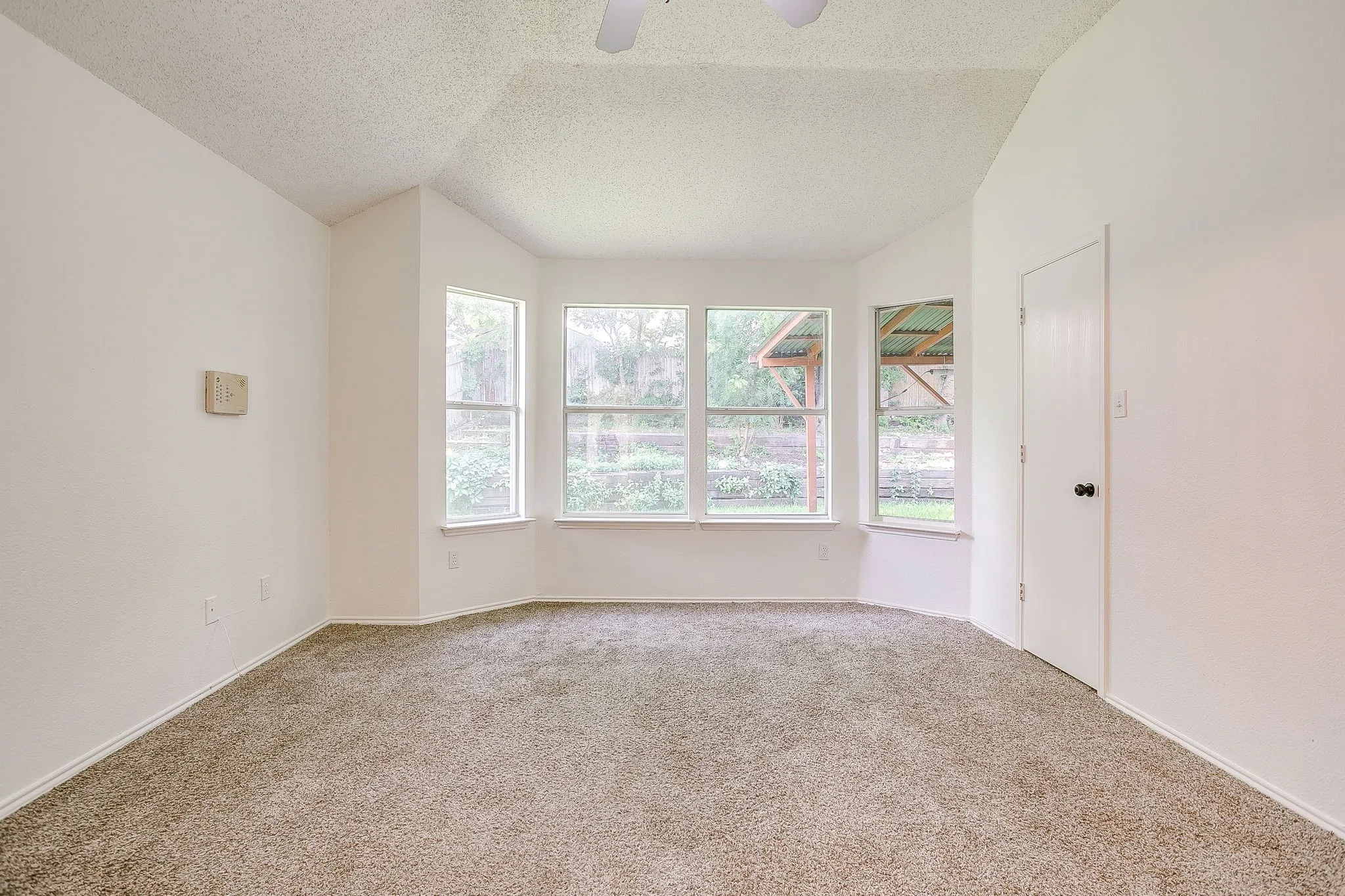 Primary bedroom featuring four large bay windows for ample natural light.