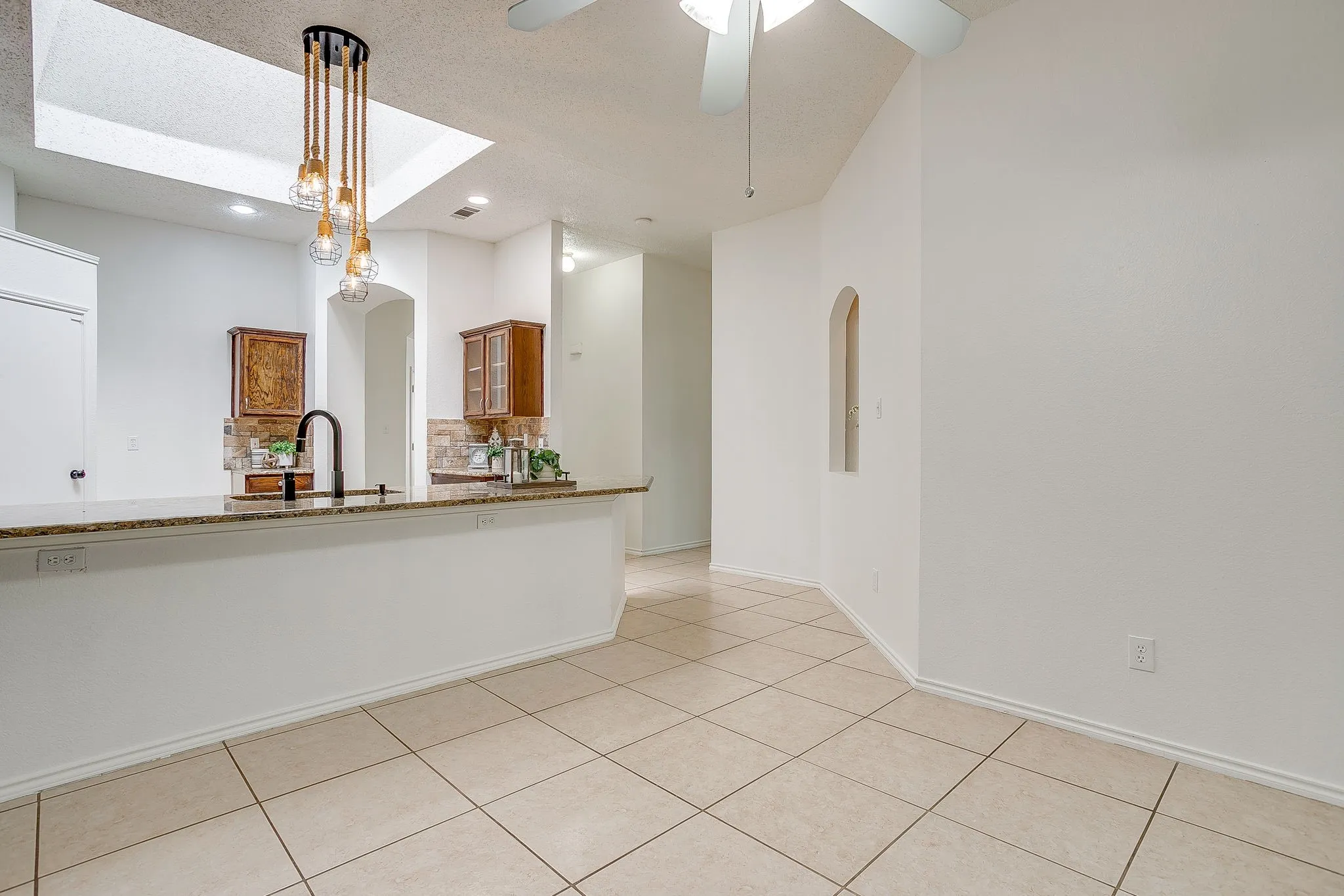 The dining area open directly into the kitchen featuring tile throughout.