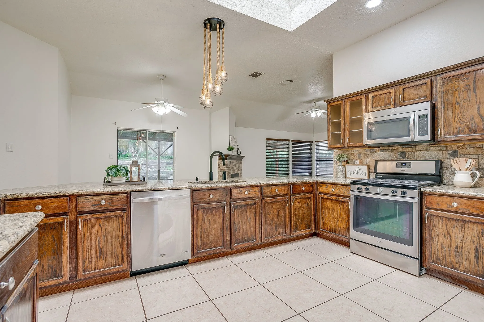 Kitchen featuring a L-shaped arrangement of cabinets.
