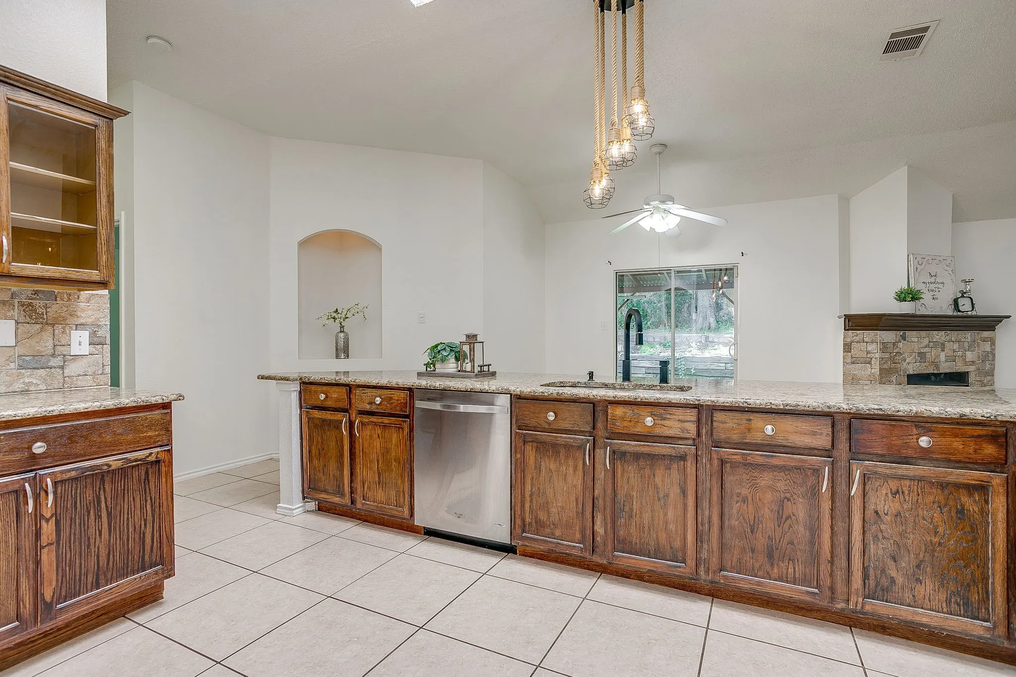 The spacious kitchen featuring decorative lighting.
