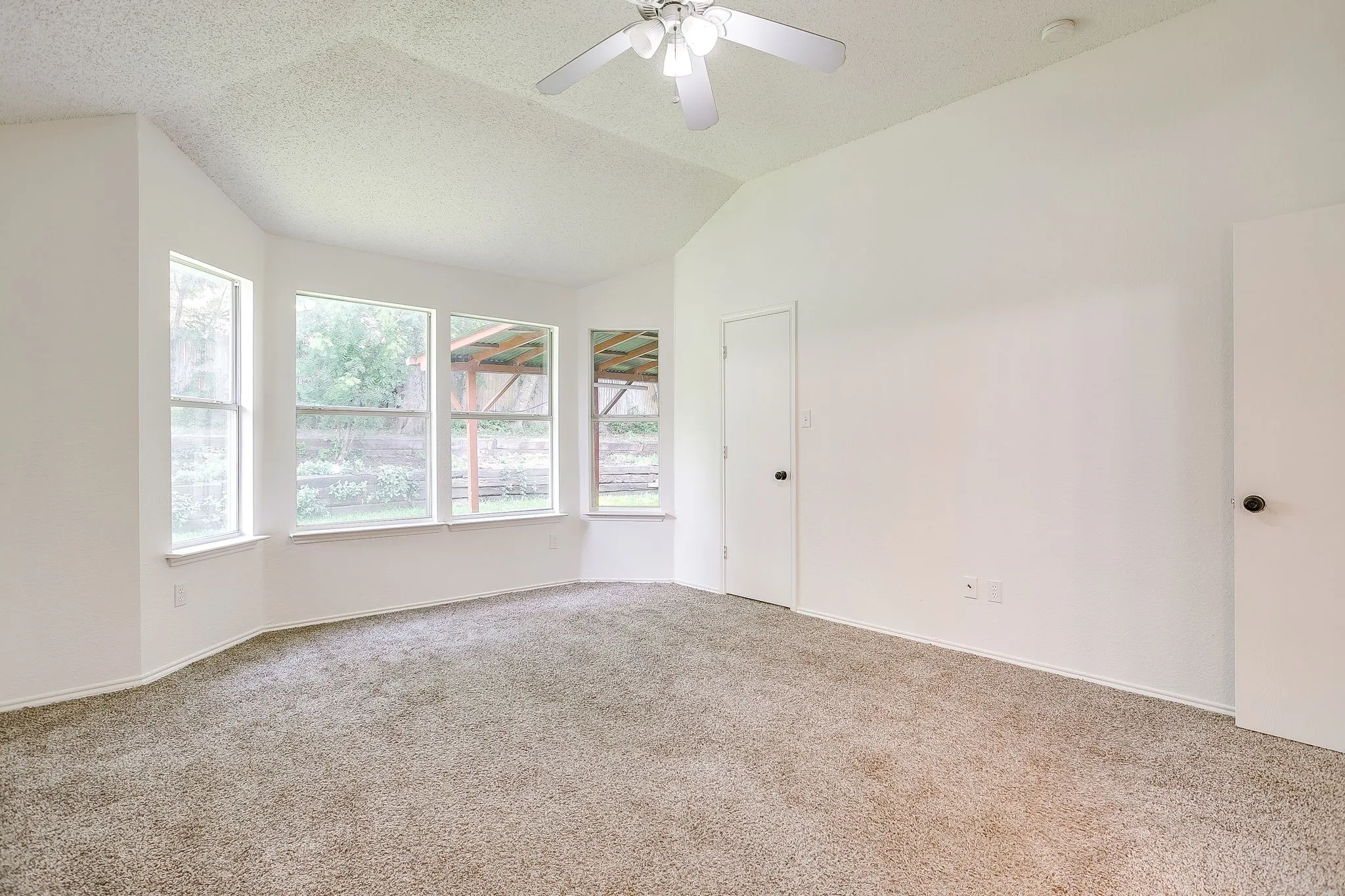 Primary bedroom featuring natural toned carpet.