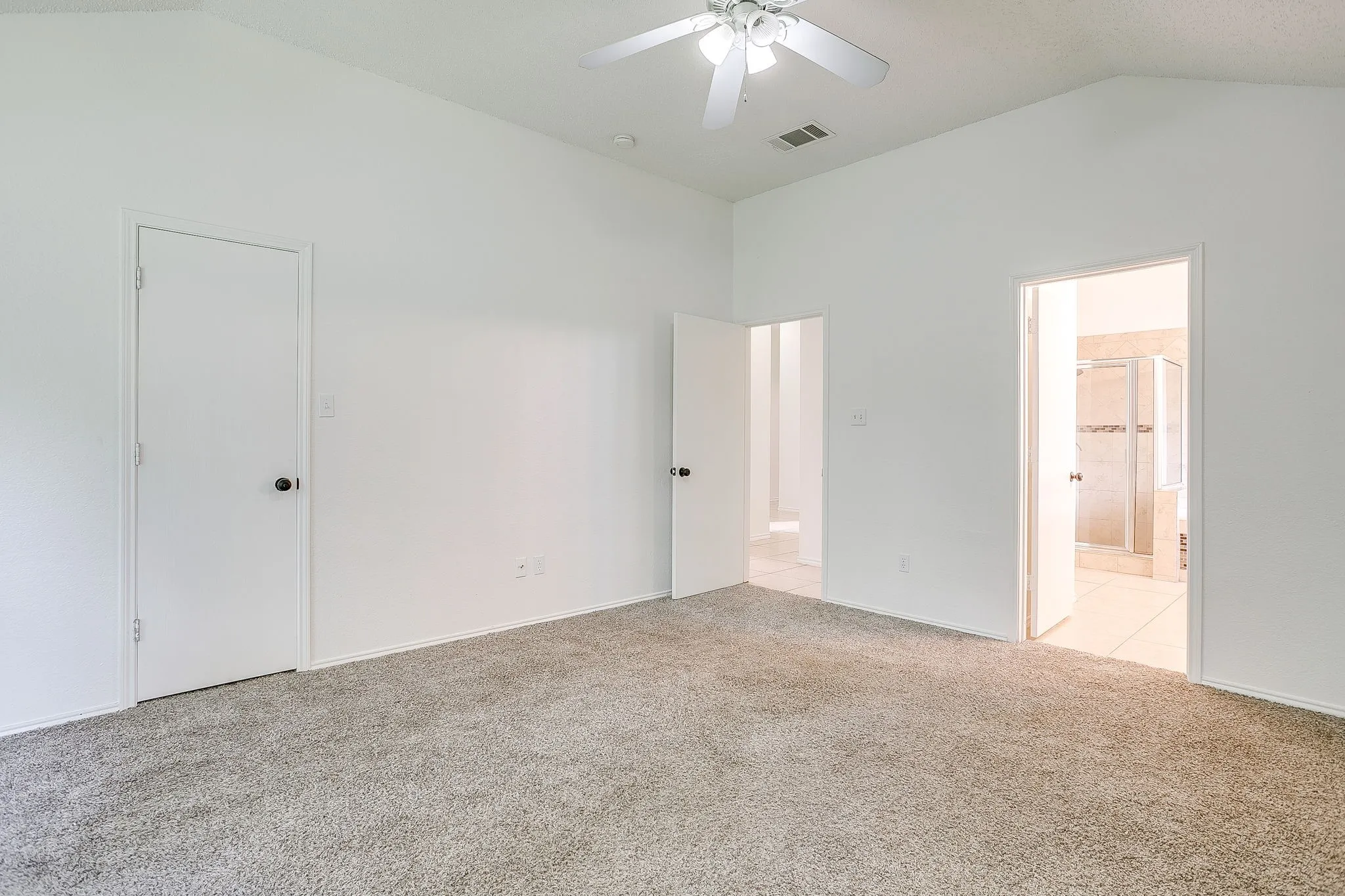 Primary bedroom featuring an ensuite bathroom.