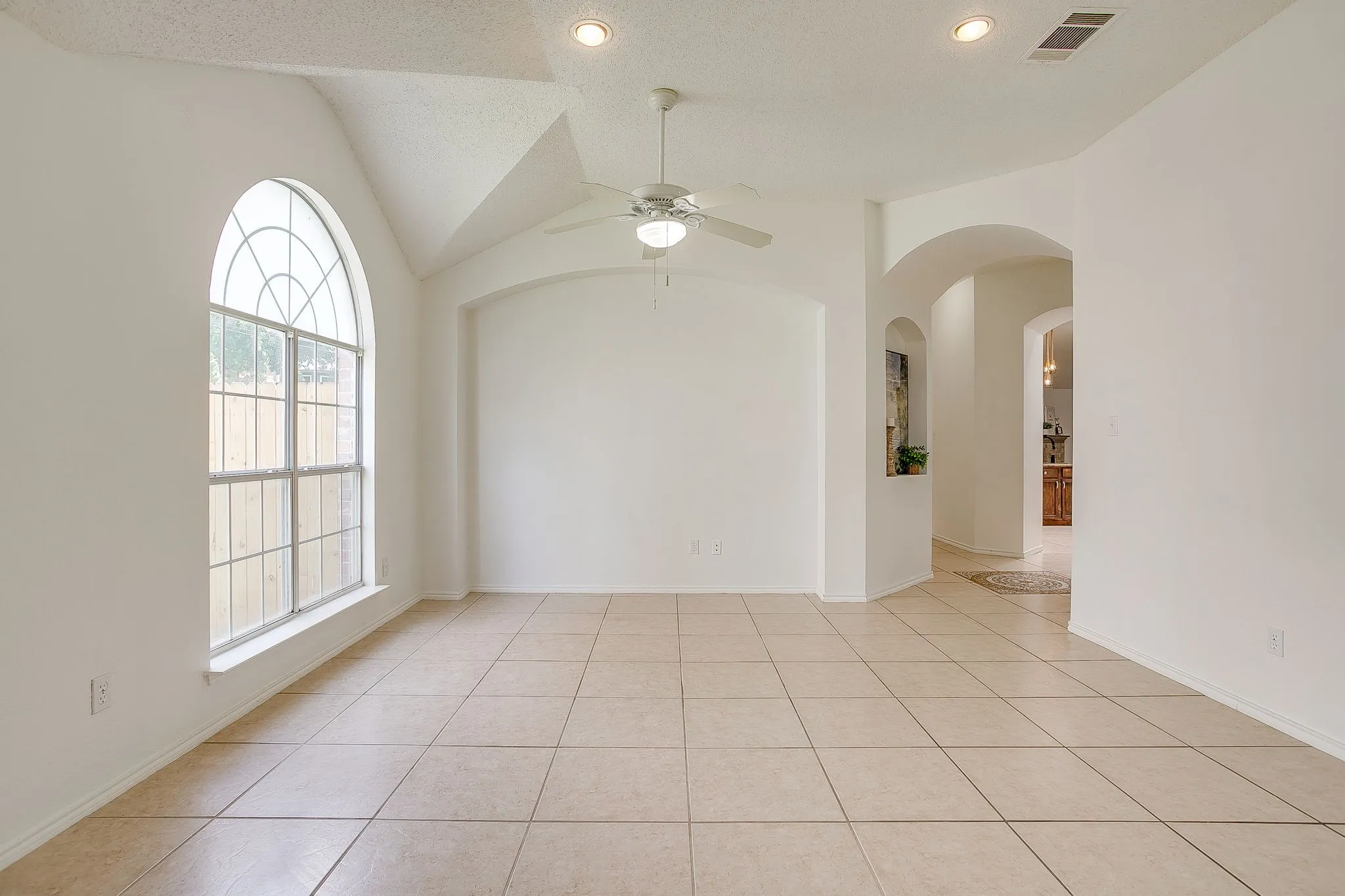The great room featuring a white ceiling fan with light.