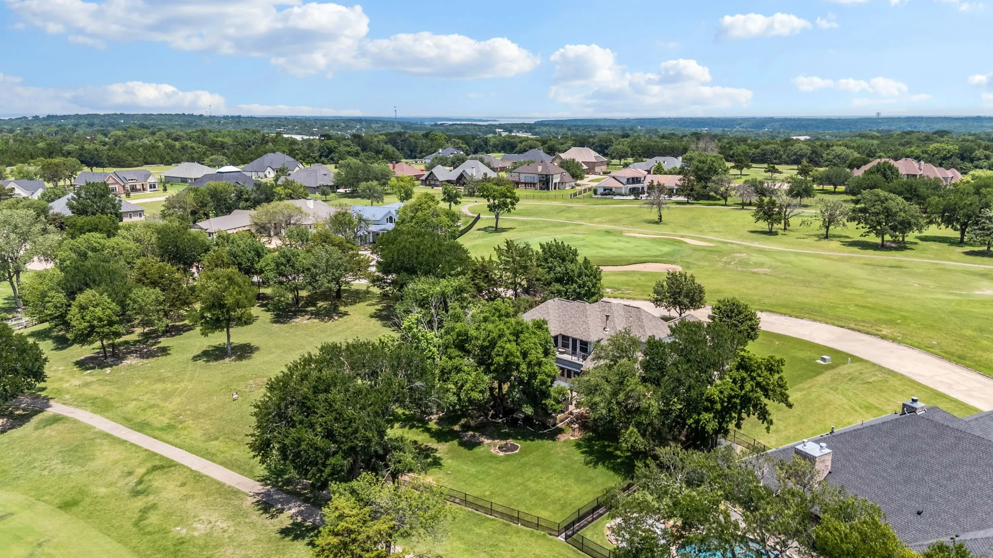 Expansive golf course setting featuring manicured fairways and mature trees