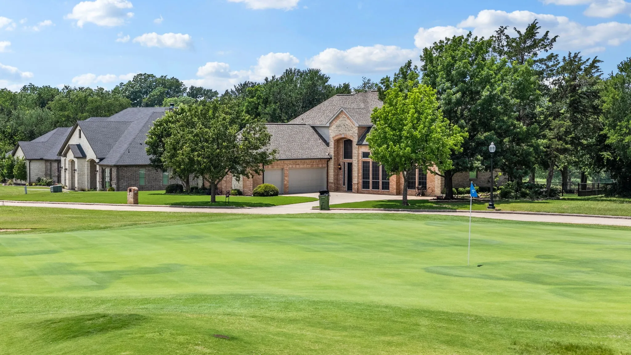 Expansive golf course green featuring a flagstick and cup
