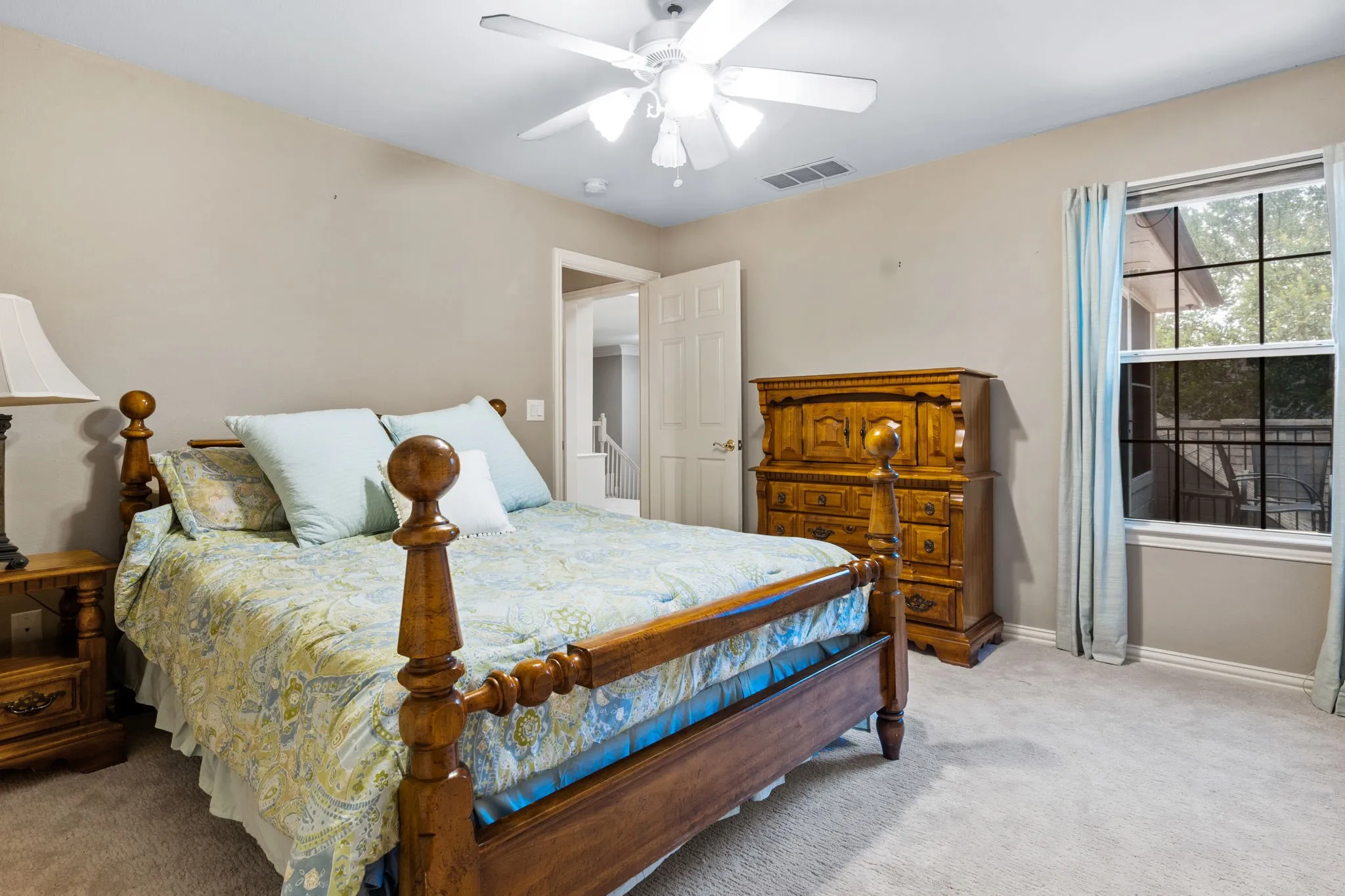 Carpeted bedroom with a window featuring grid panes and light blue​​‌​​​​‌​​‌‌​‌‌​​​‌‌​‌​‌​‌​​​‌​​ curtains