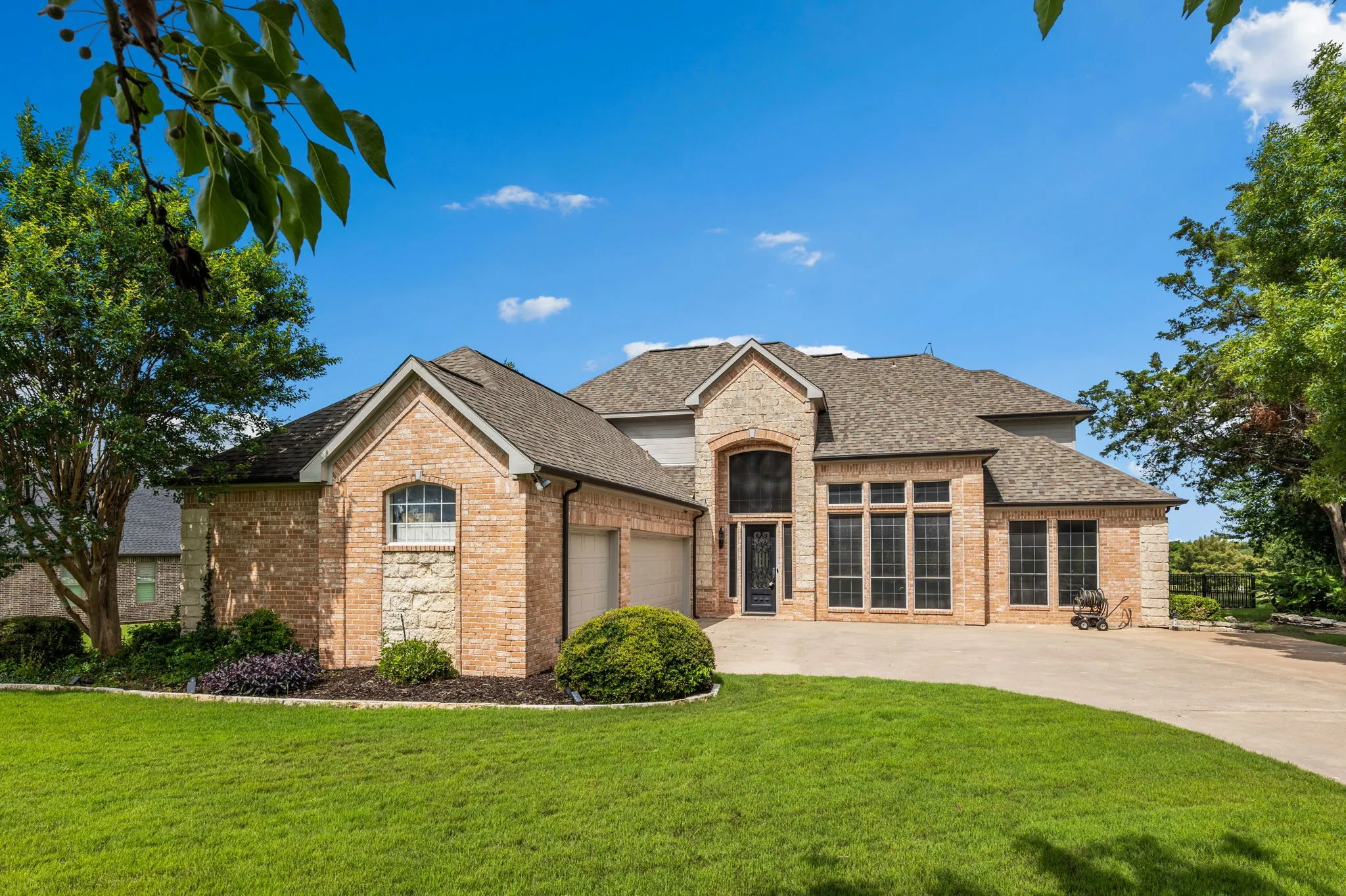 Brick and stone-clad exterior with a multi-gabled roofline
